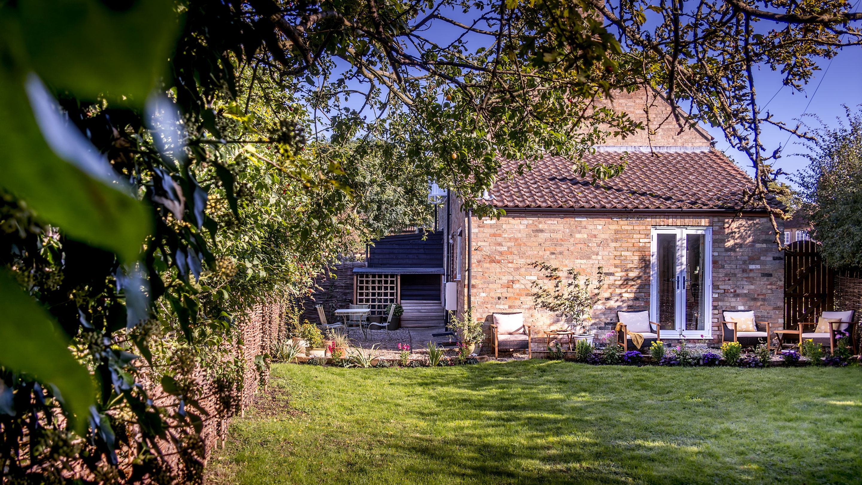 Looking towards Cladium from the end of the back garden, across the lawn and gravel patio, Cambridgeshire