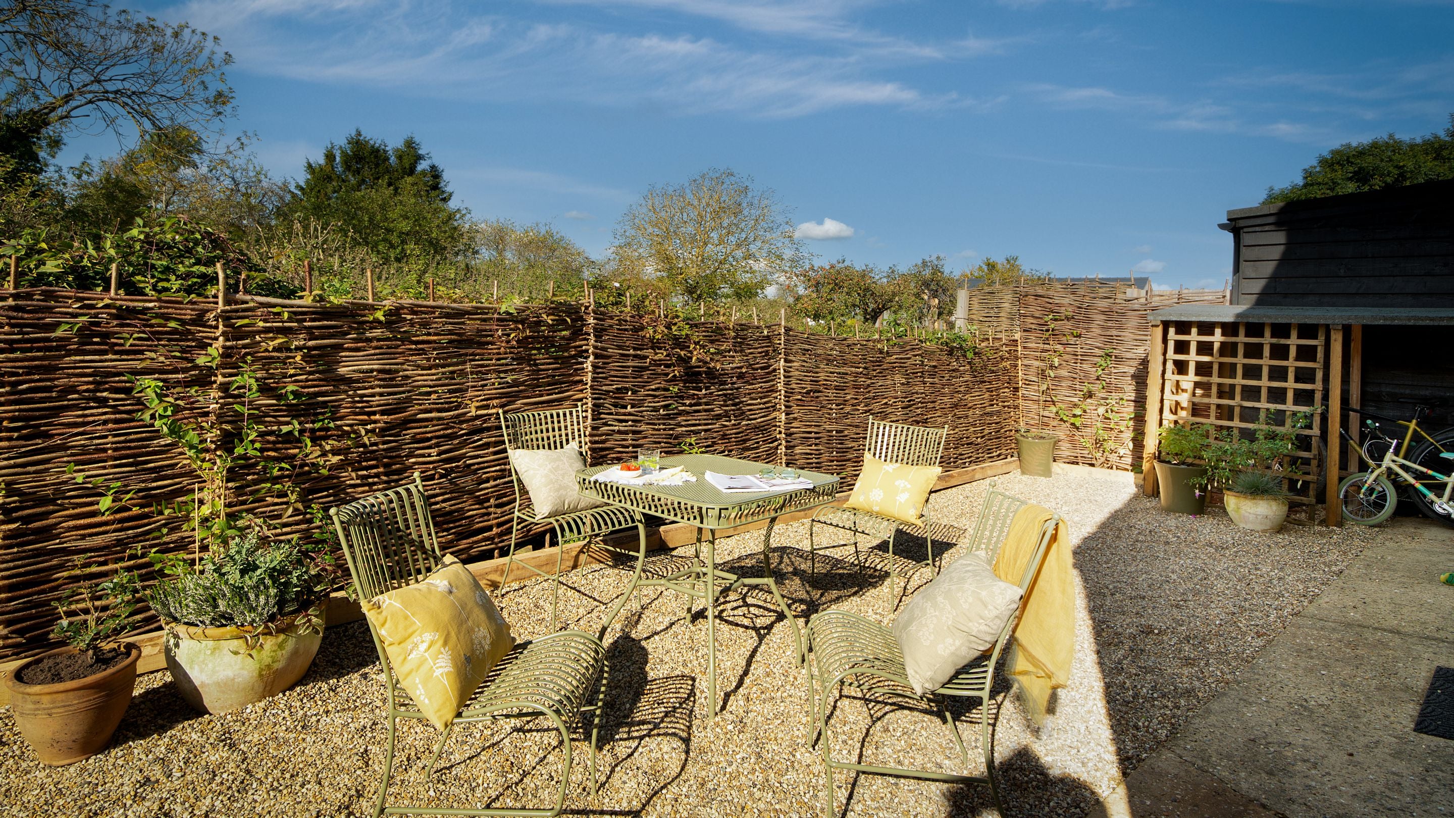 The gravel patio with outdoor dining furniture at the back of Cladium, Cambridgeshire