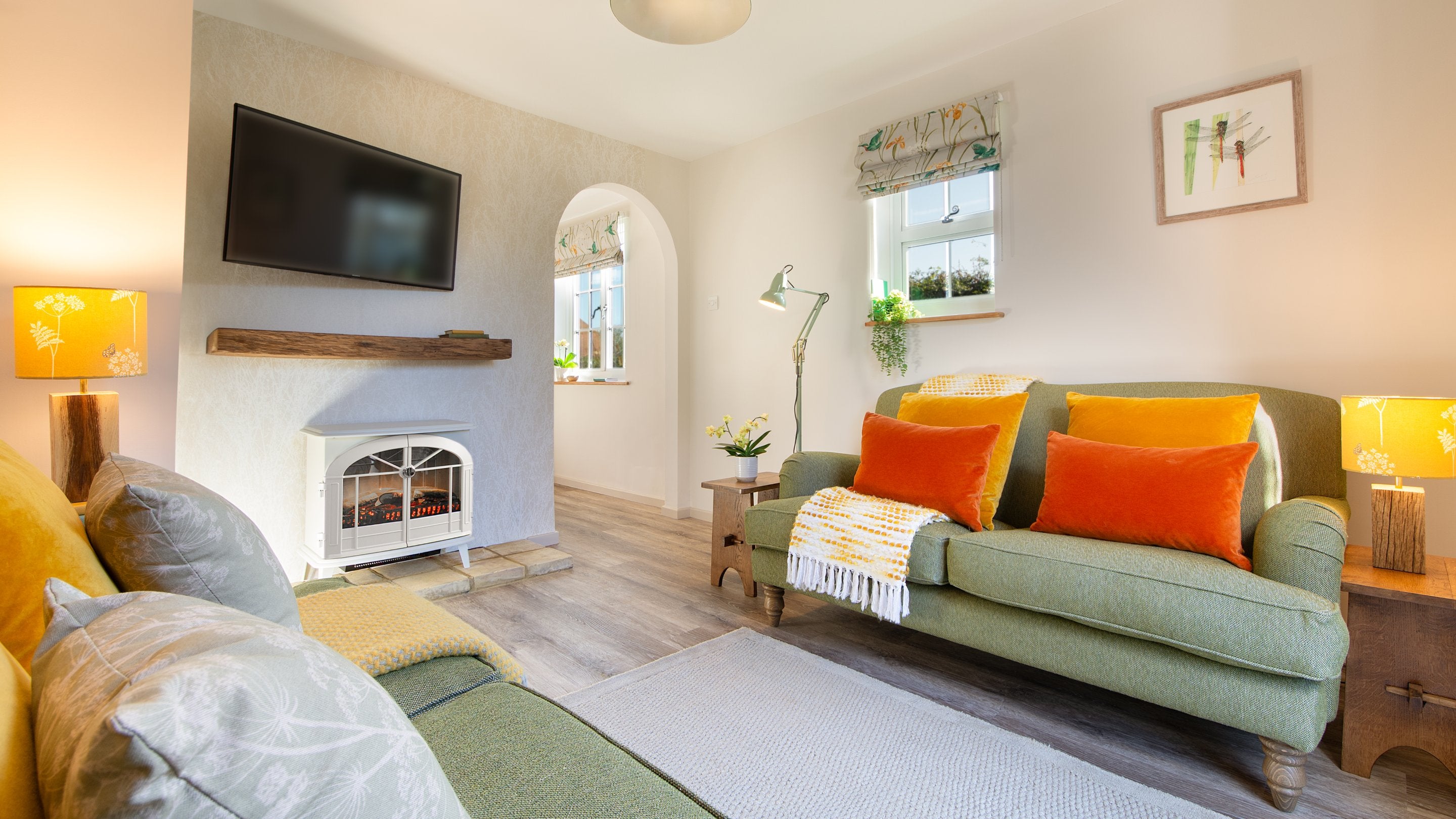 The sitting room at Cladium, showing the two sofas, television and electric fire, Cambridgeshire