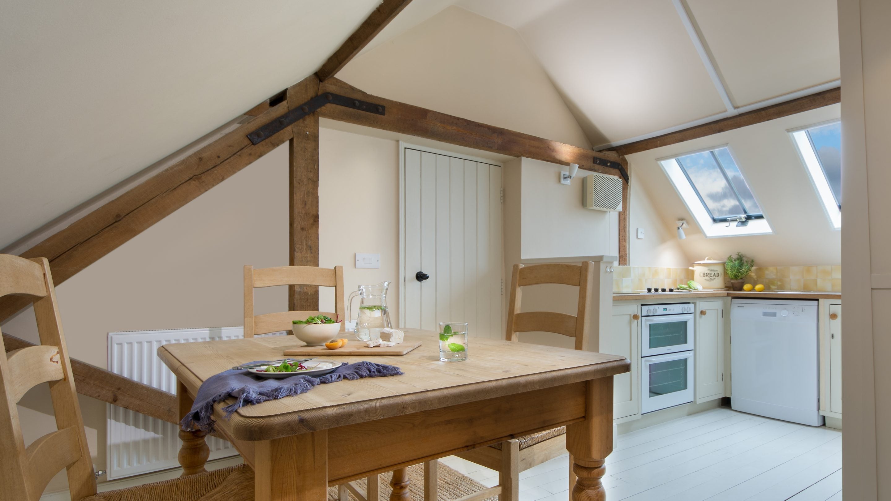 The table in the kitchen in the open-plan area at Coach House Loft, Cambridgeshire