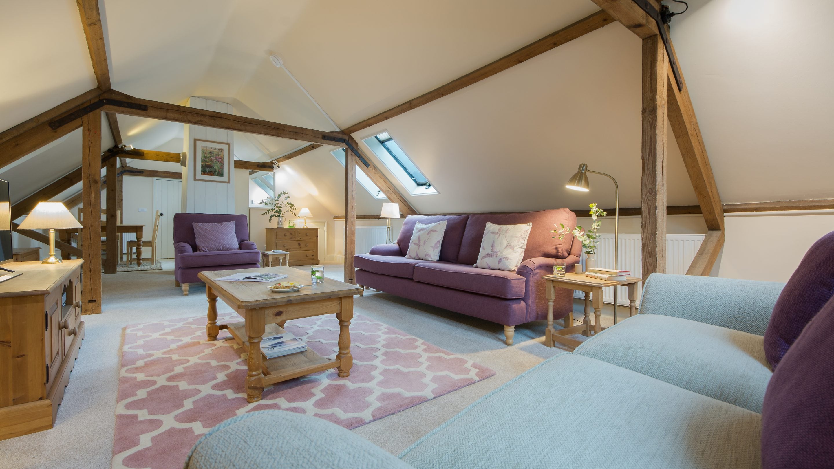 The sitting room area looking towards the kitchen in the open-plan area at Coach House Loft, Cambridgeshire