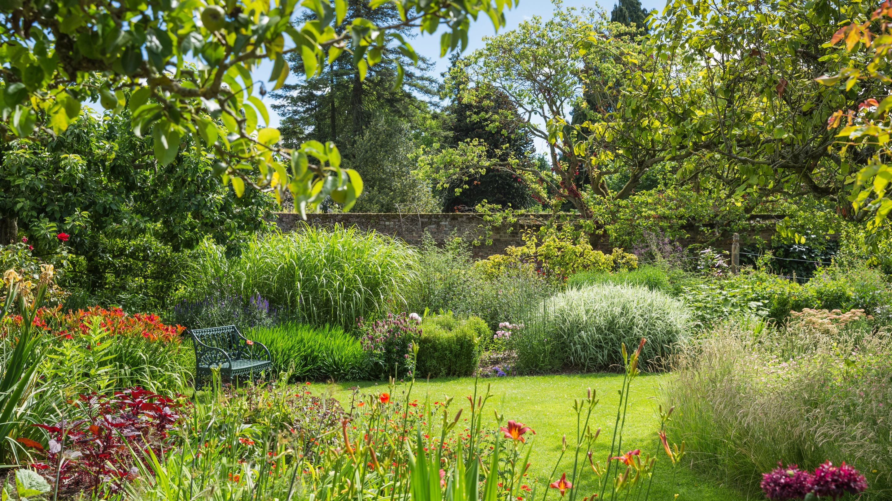 The Red Border and Centenary Border in July at Peckover House and Garden, Cambridgeshire