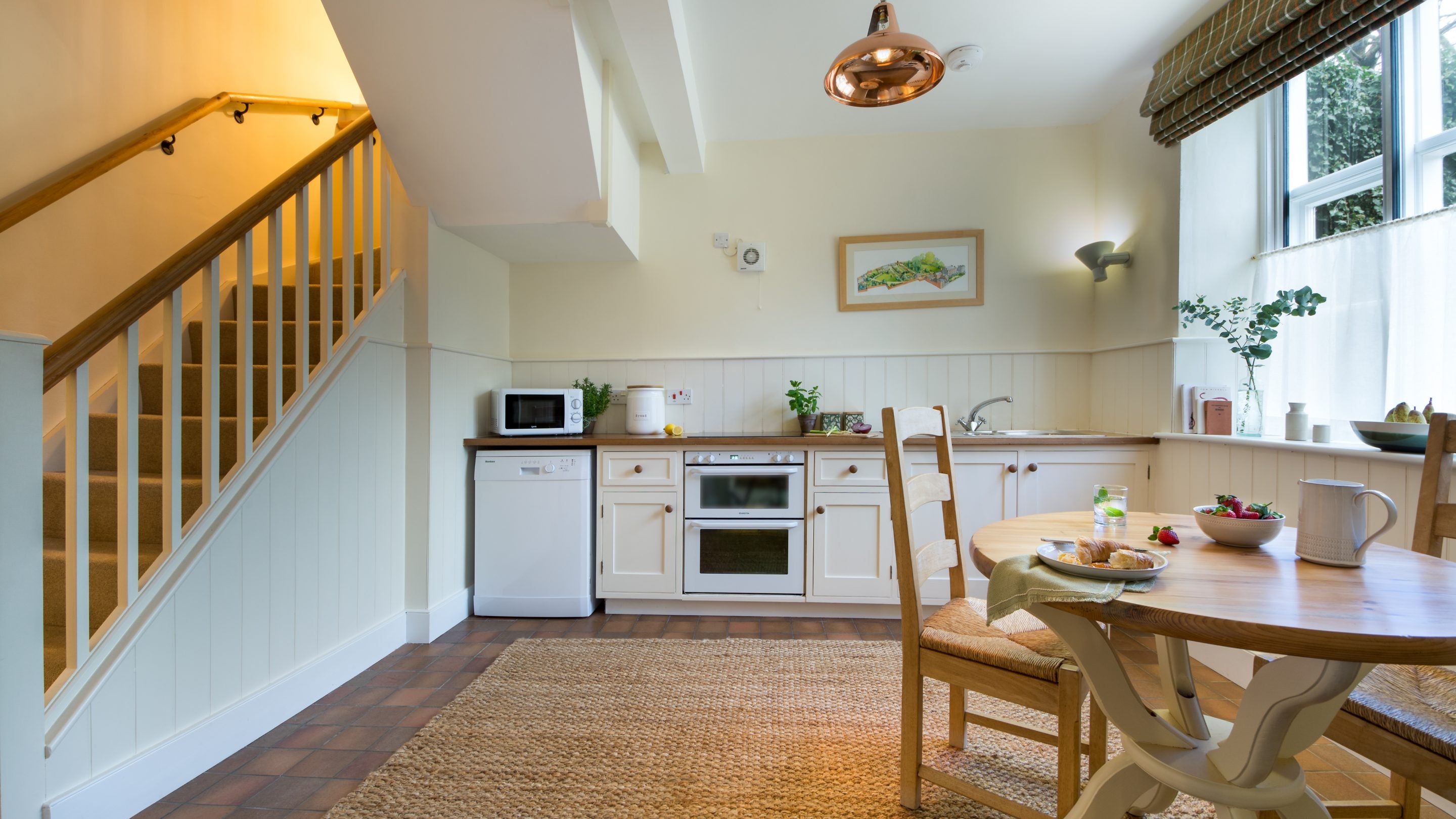 The kitchen and stairs leading up to the first floor at Peckover Stable Lodge, Cambridgeshire