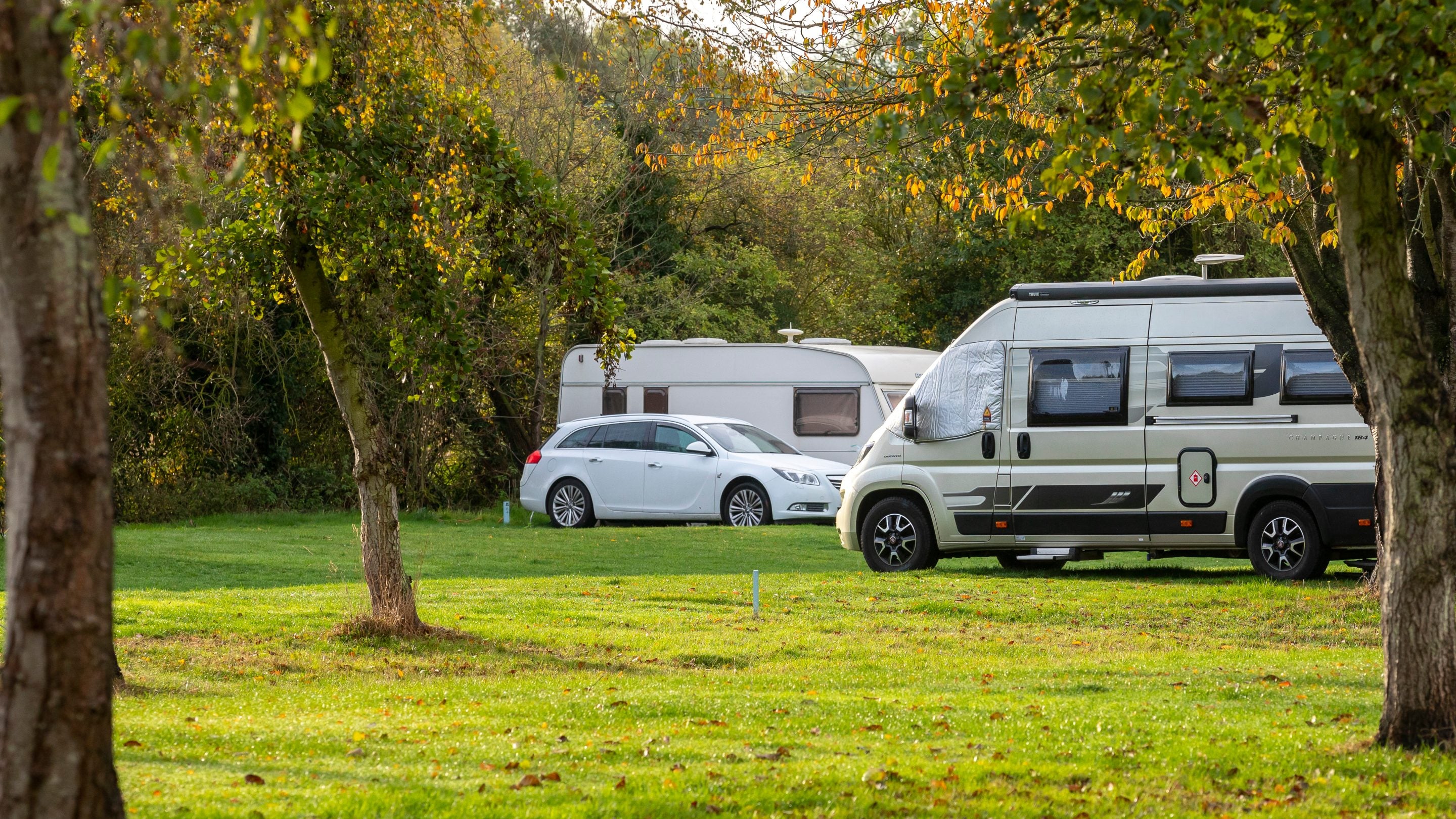 Campervans and caravans pitched at Waterclose Meadows Campsite, Cambridgeshire