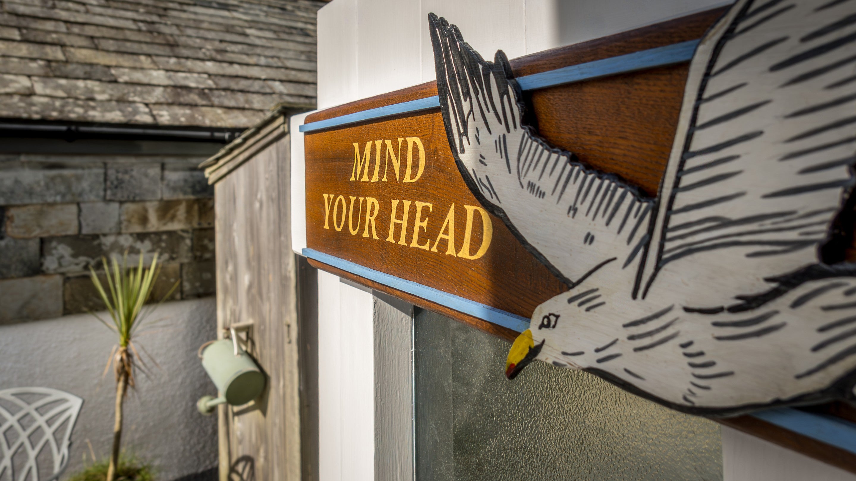 A sign saying "Mind your head" for the low ceilings at The Birdcage, Cornwall