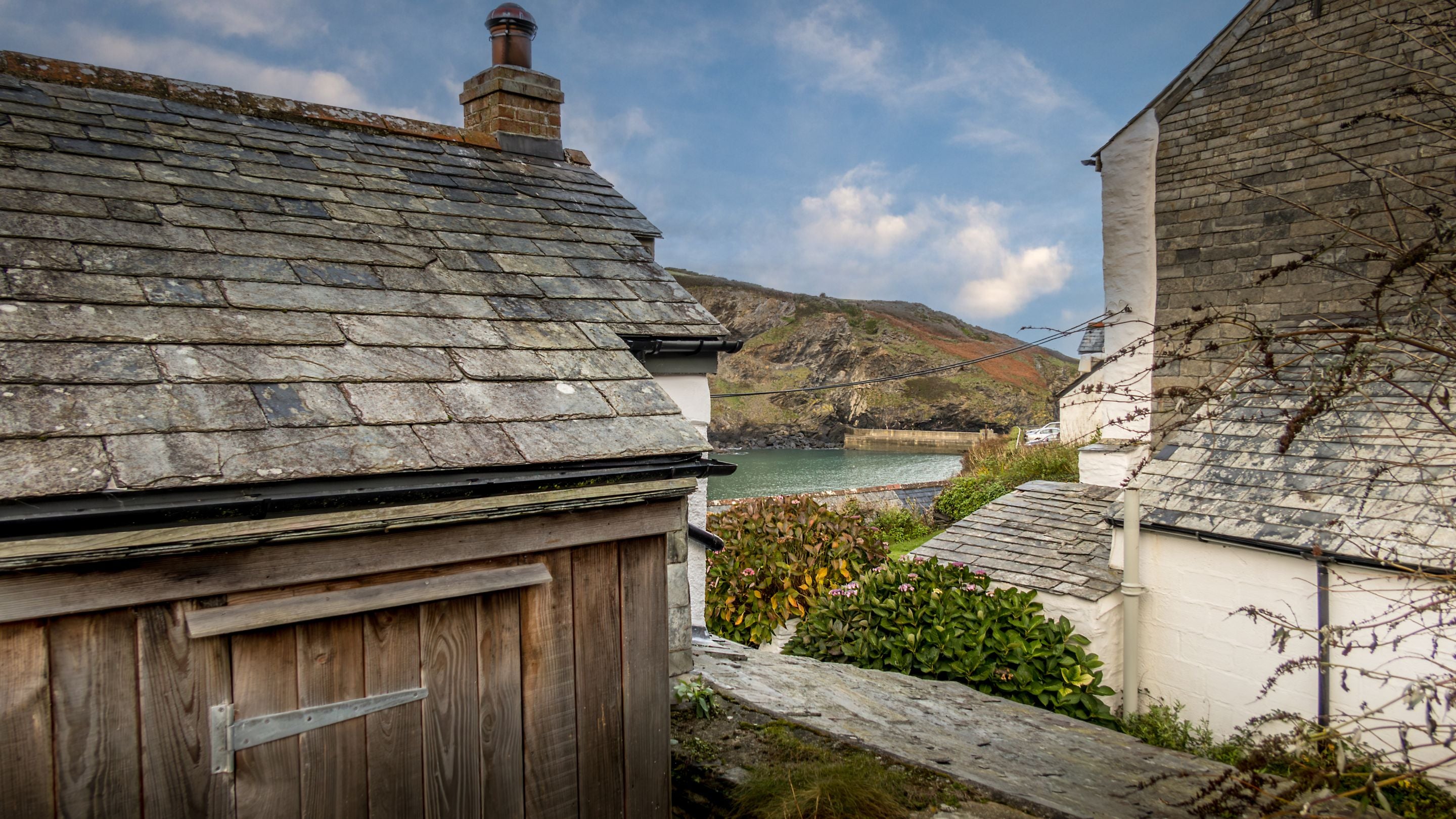 The sea view over the wall of The Birdcage's garden, Cornwall