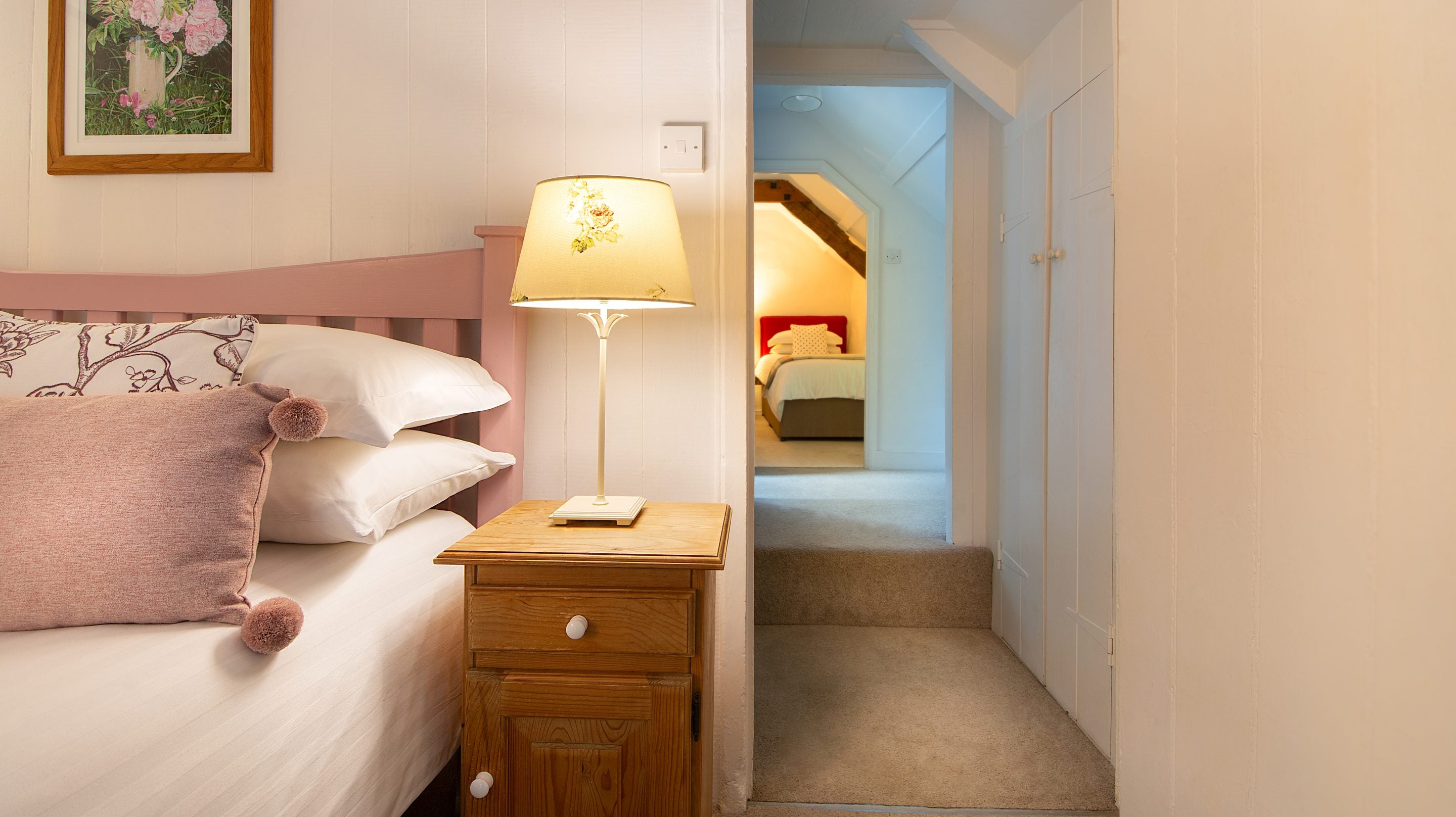The double bedroom, with the twin bedroom in the background, at Boscastle Elm Cottage, Cornwall