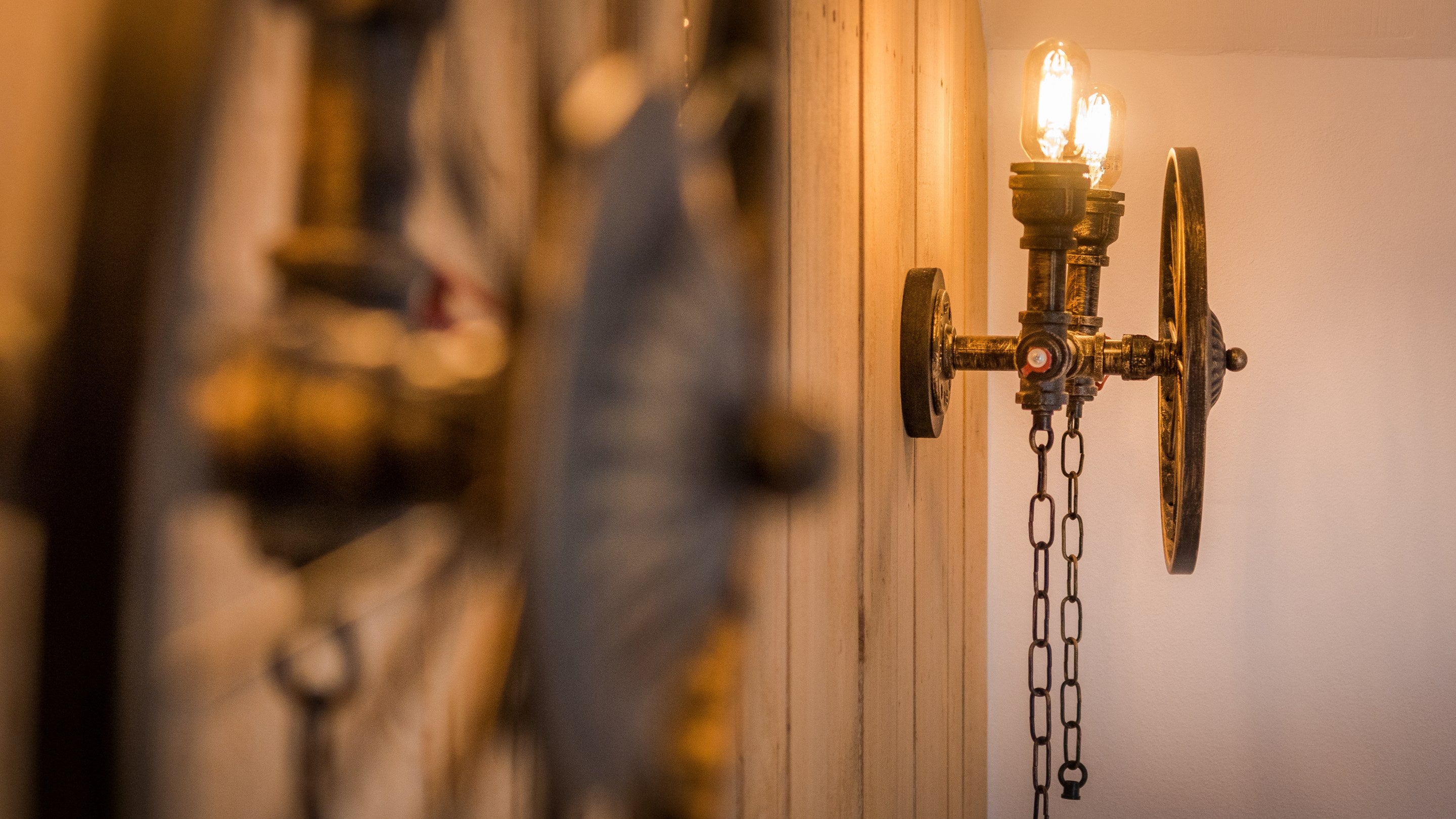 Light fixtures made from old farming equipment in the double bedroom at Bosigran Cottage, Cornwall