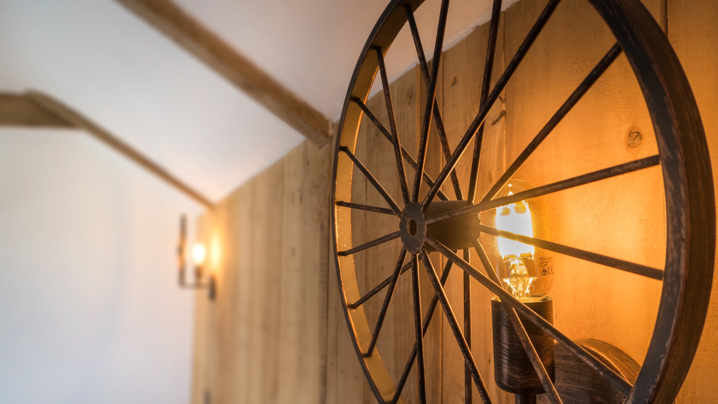 Light fixtures made from old farming equipment in the twin bedroom at Bosigran Cottage, Cornwall