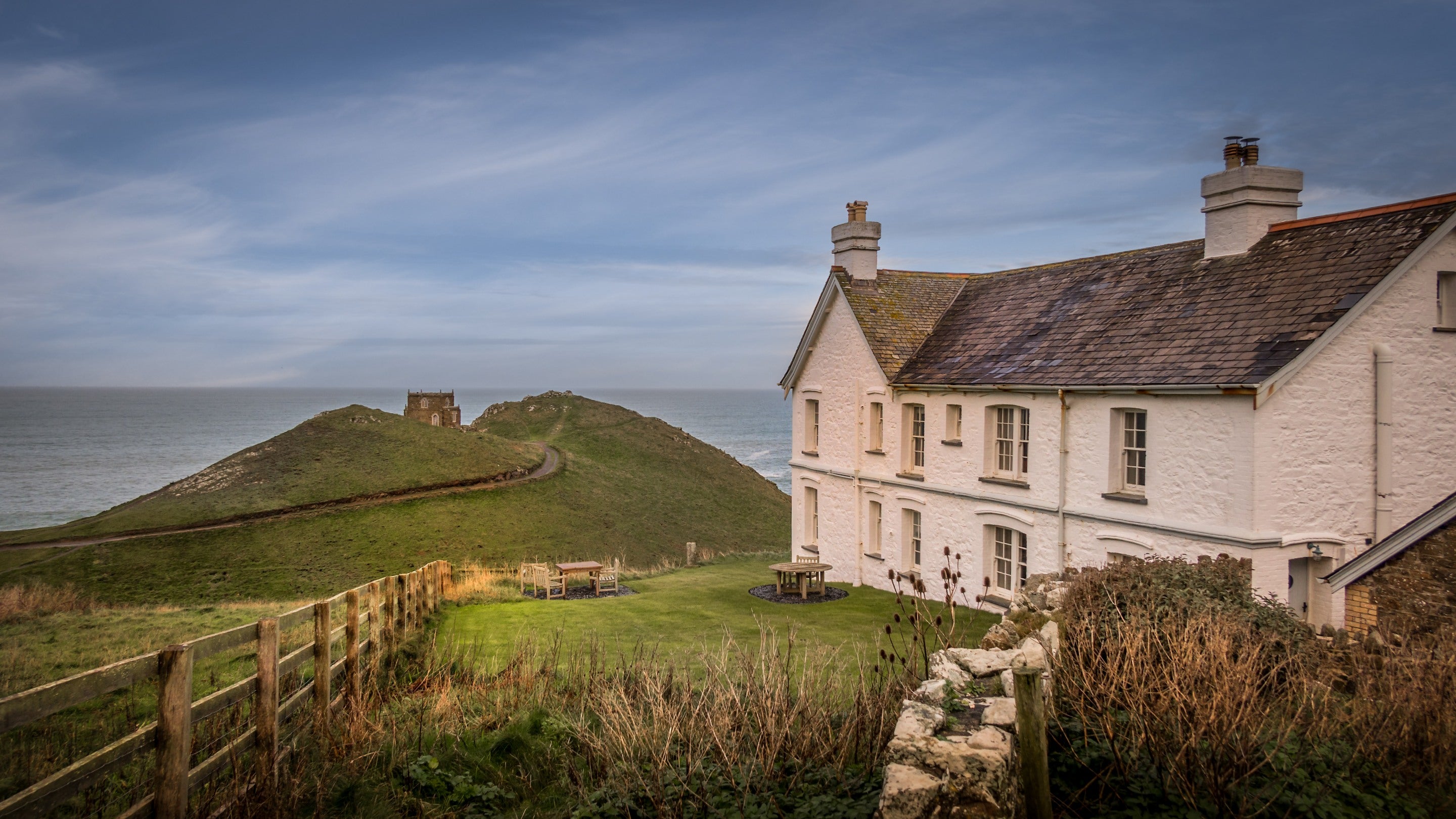 Doyden House and the garden shared by Carnweather, Mouls, Rumps and Conor holiday apartments, with views of Doyden Castle and the sea, Cornwall