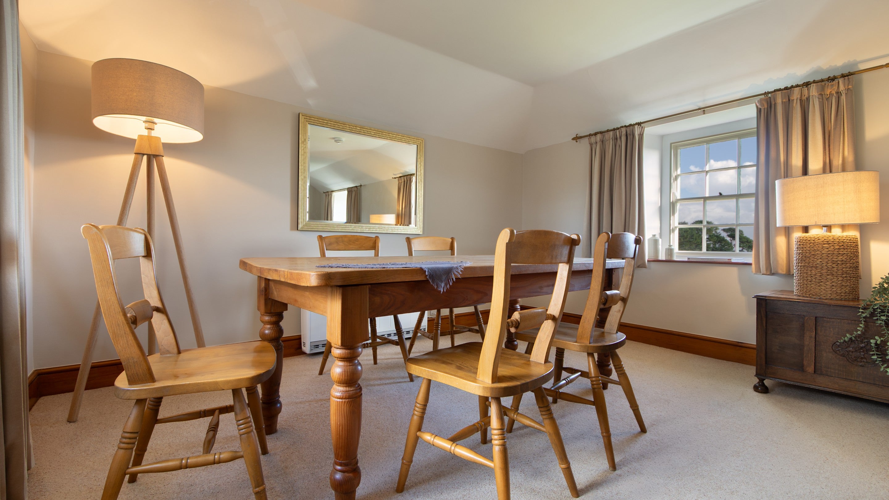The table in the open-plan dining and sitting room at Chenhalls Barn, Cornwall