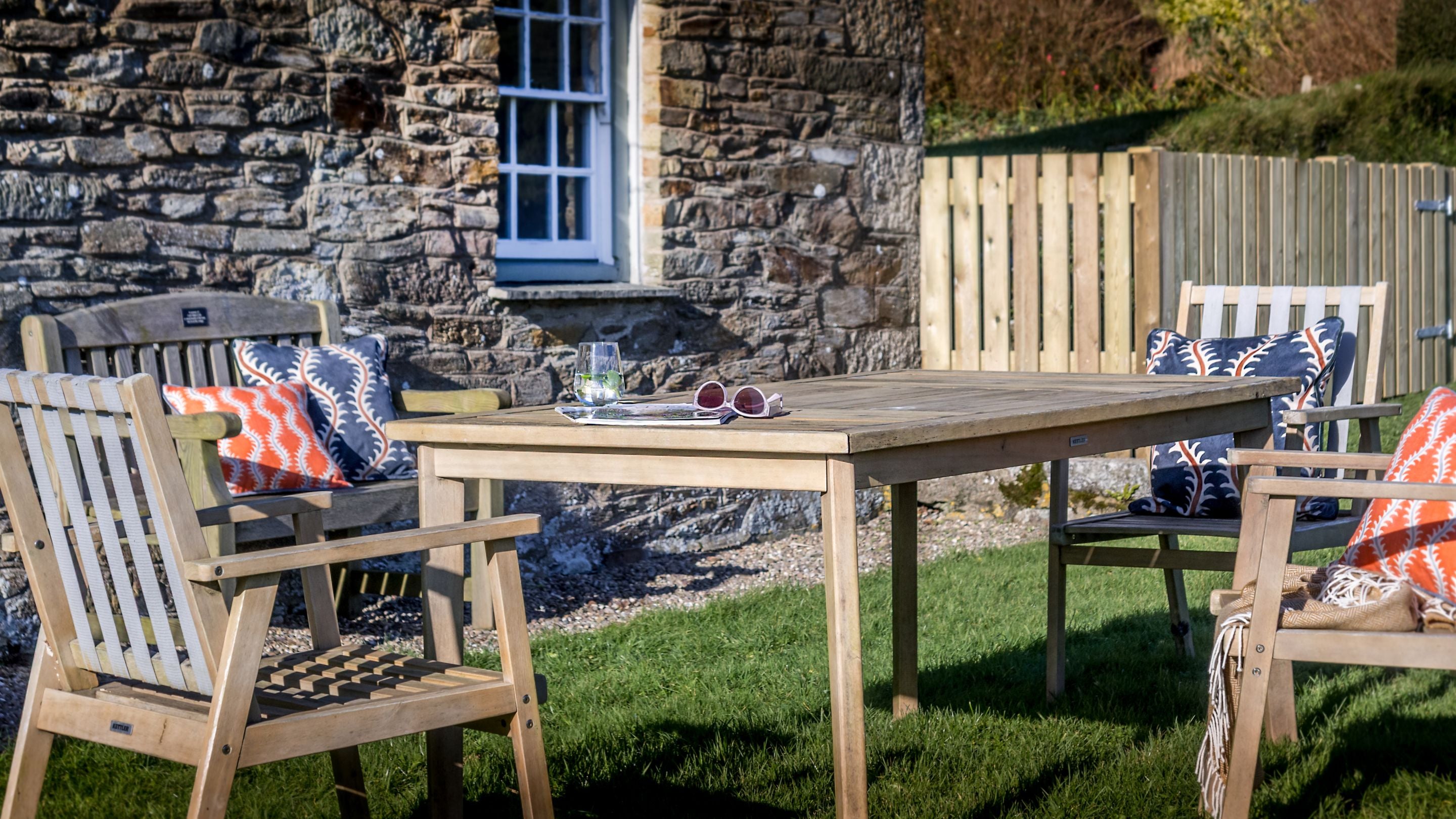The outdoor dining table and chairs in the garden at Chenhalls Barn, Cornwall