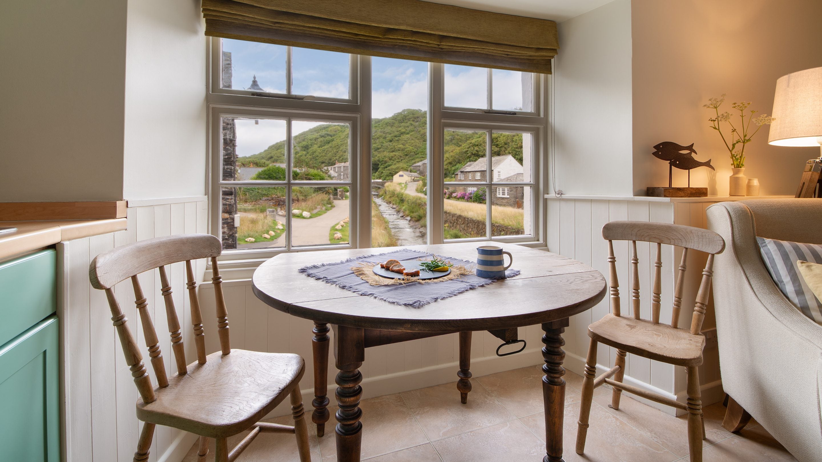 The open-plan room with sitting area, dining table and kitchen at The Clinker, Cornwall