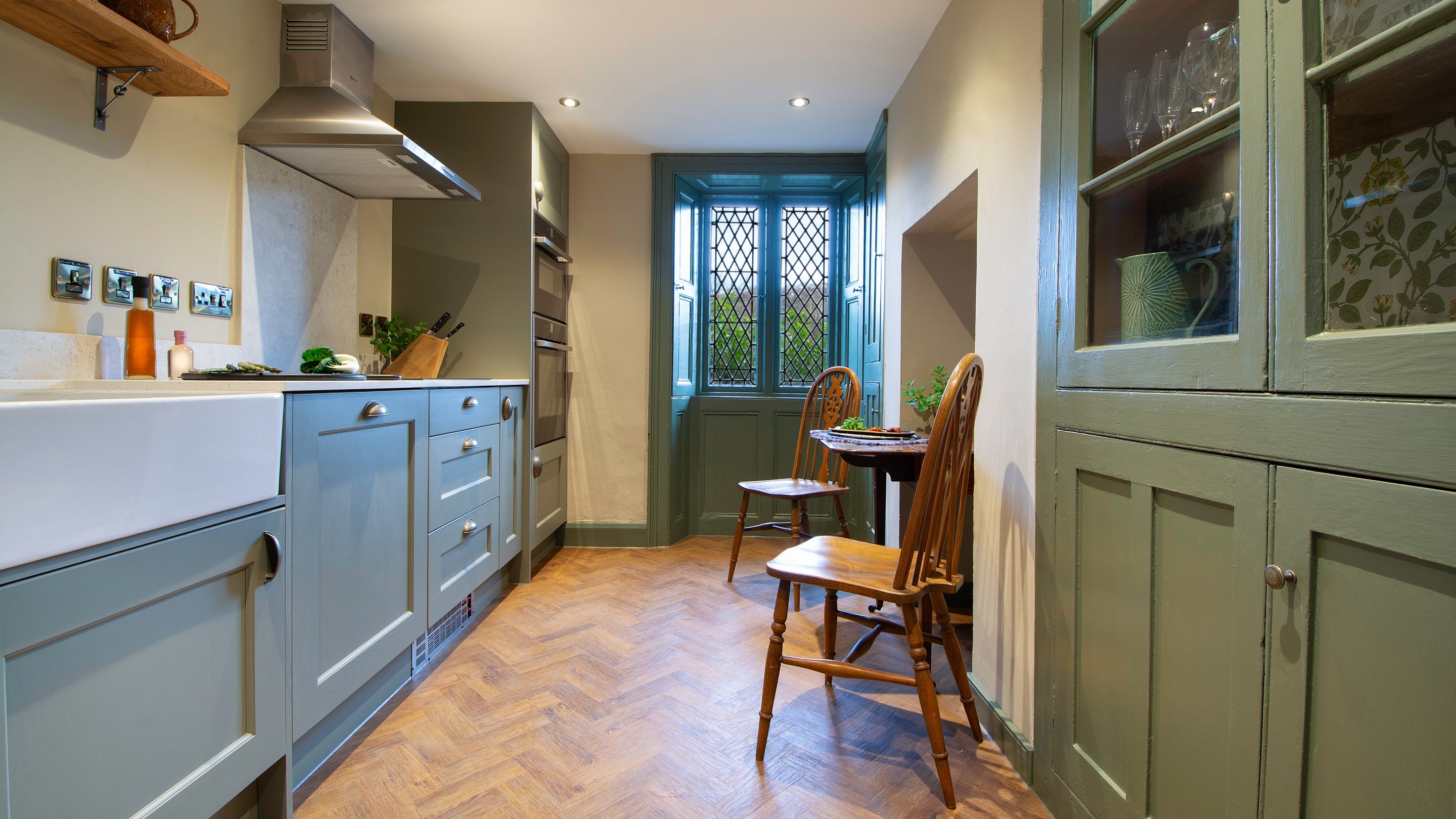 The kitchen with a table for two at Cotehele Quay Lodge Cottage, Cornwall