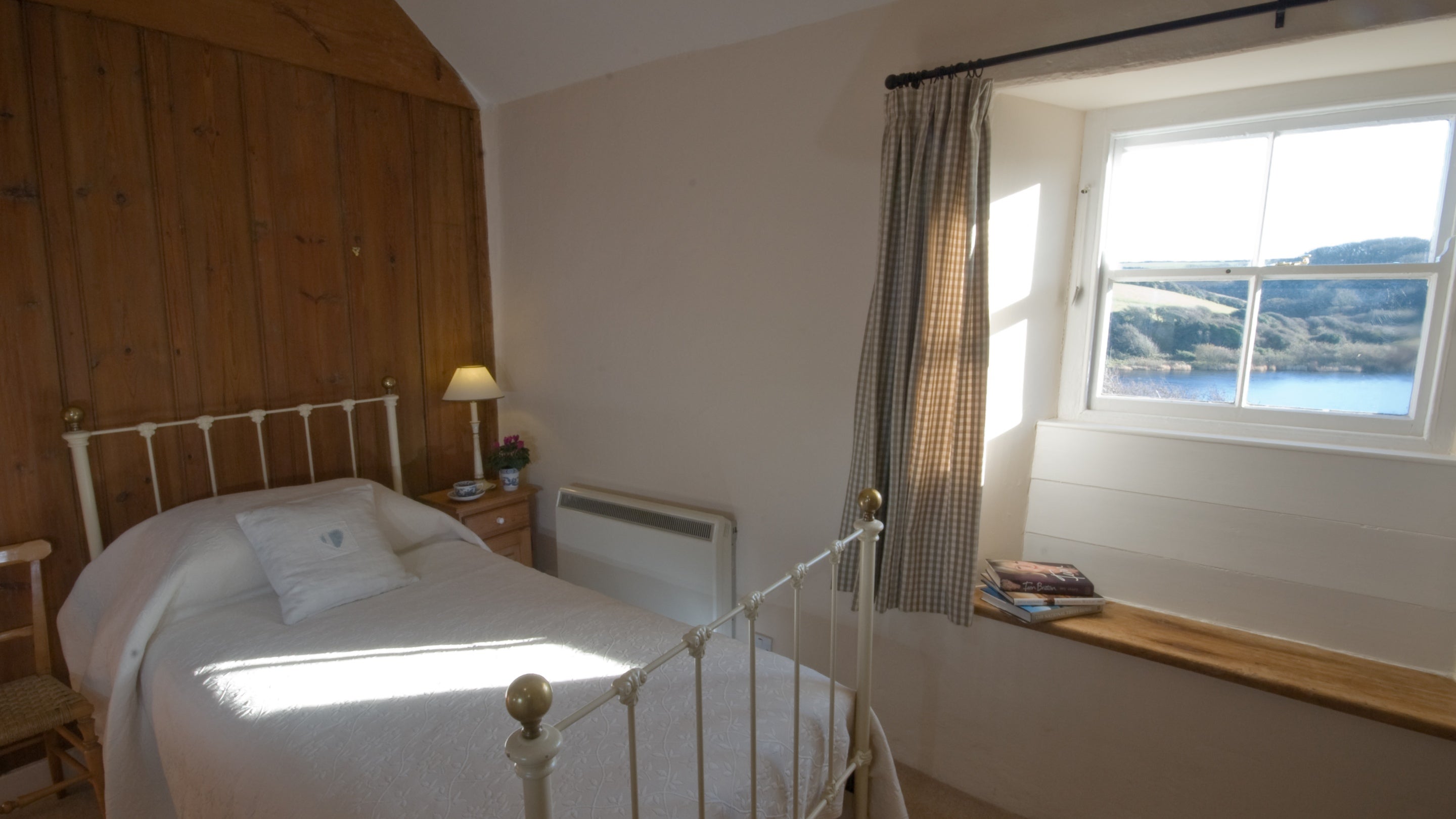 The twin bedroom at Degibna Lower Pentire Farm House has views over Loe Pool, Cornwall