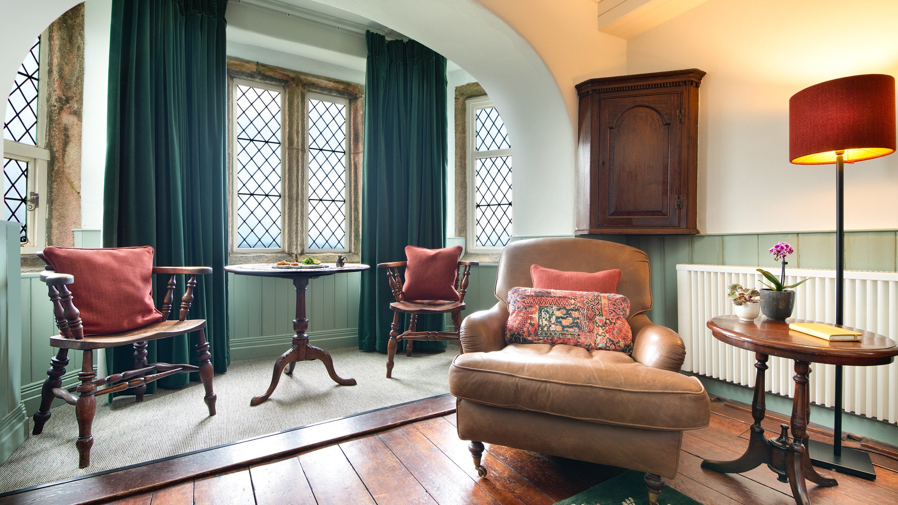 The dining area in the sitting room at Doyden Castle has sea views, Cornwall