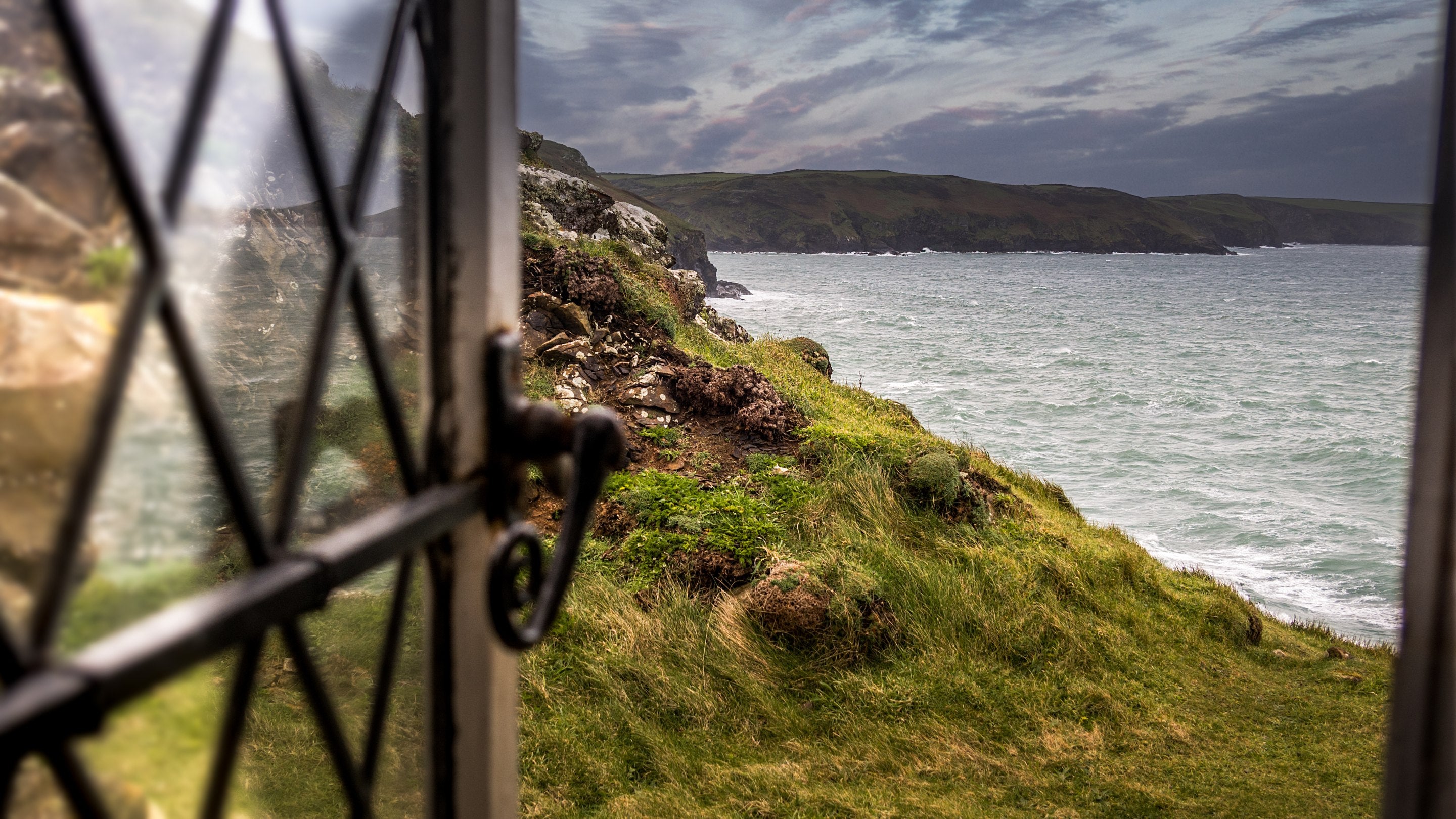 A coastal view from a window at Doyden Castle, Cornwall