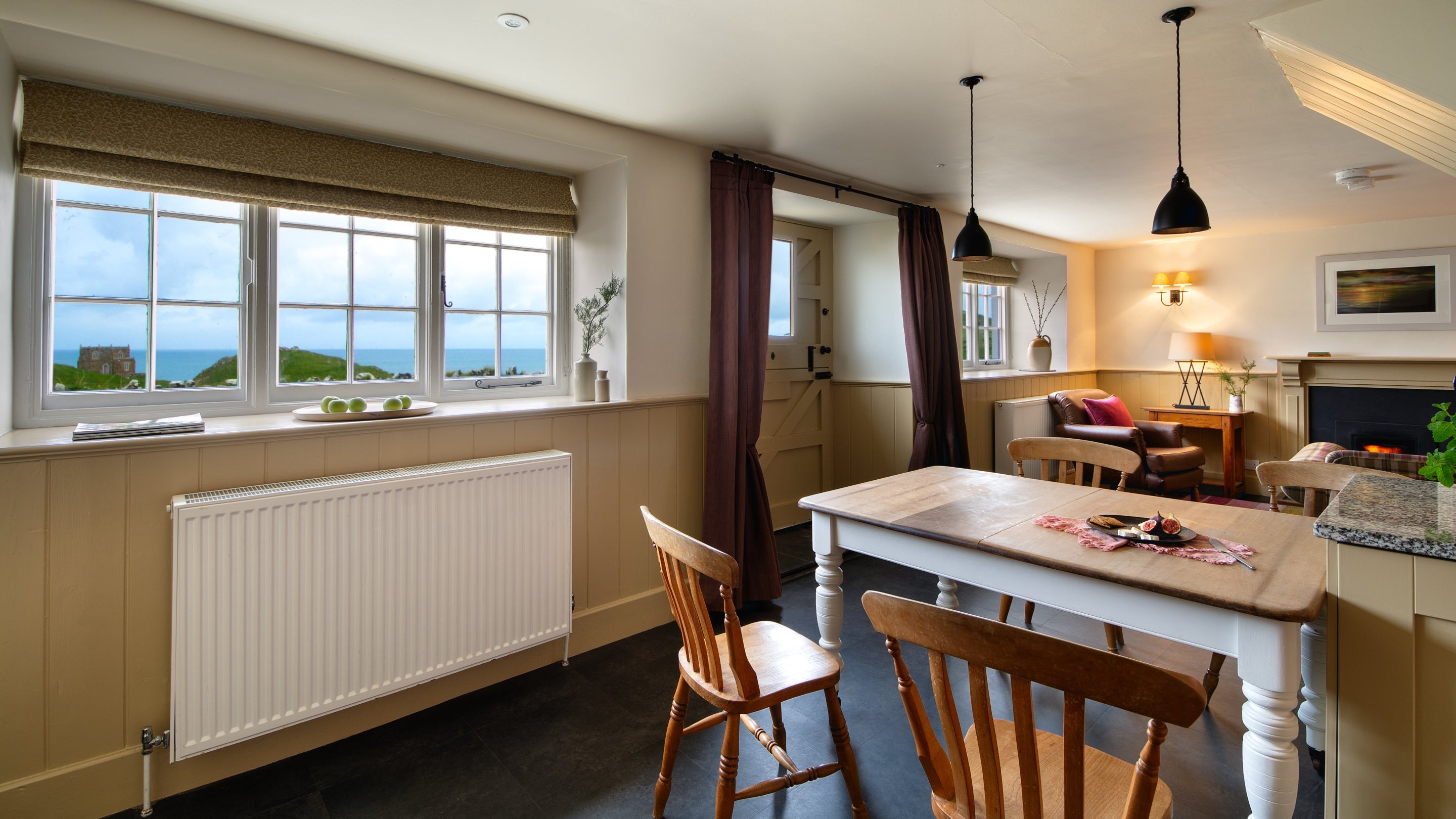 The dining area and sitting room at Doyden Stable Cottage, Cornwall