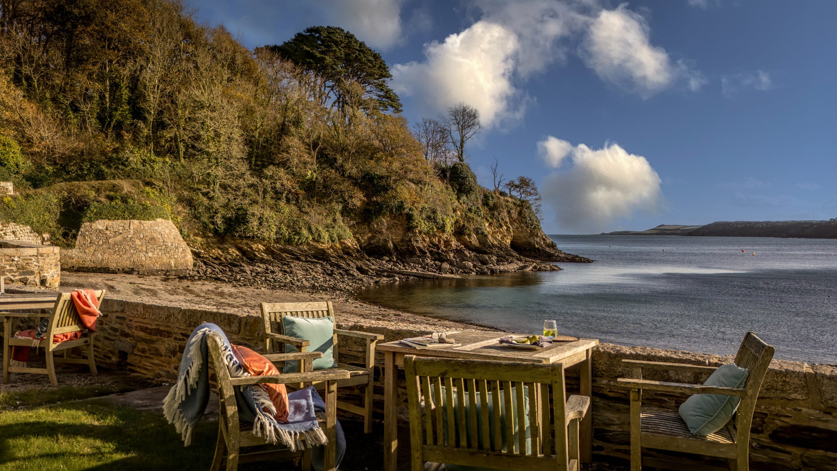 The table and chairs in the garden shared by Durgan Quay Cottage and Durgan Beach Cottage, Cornwall