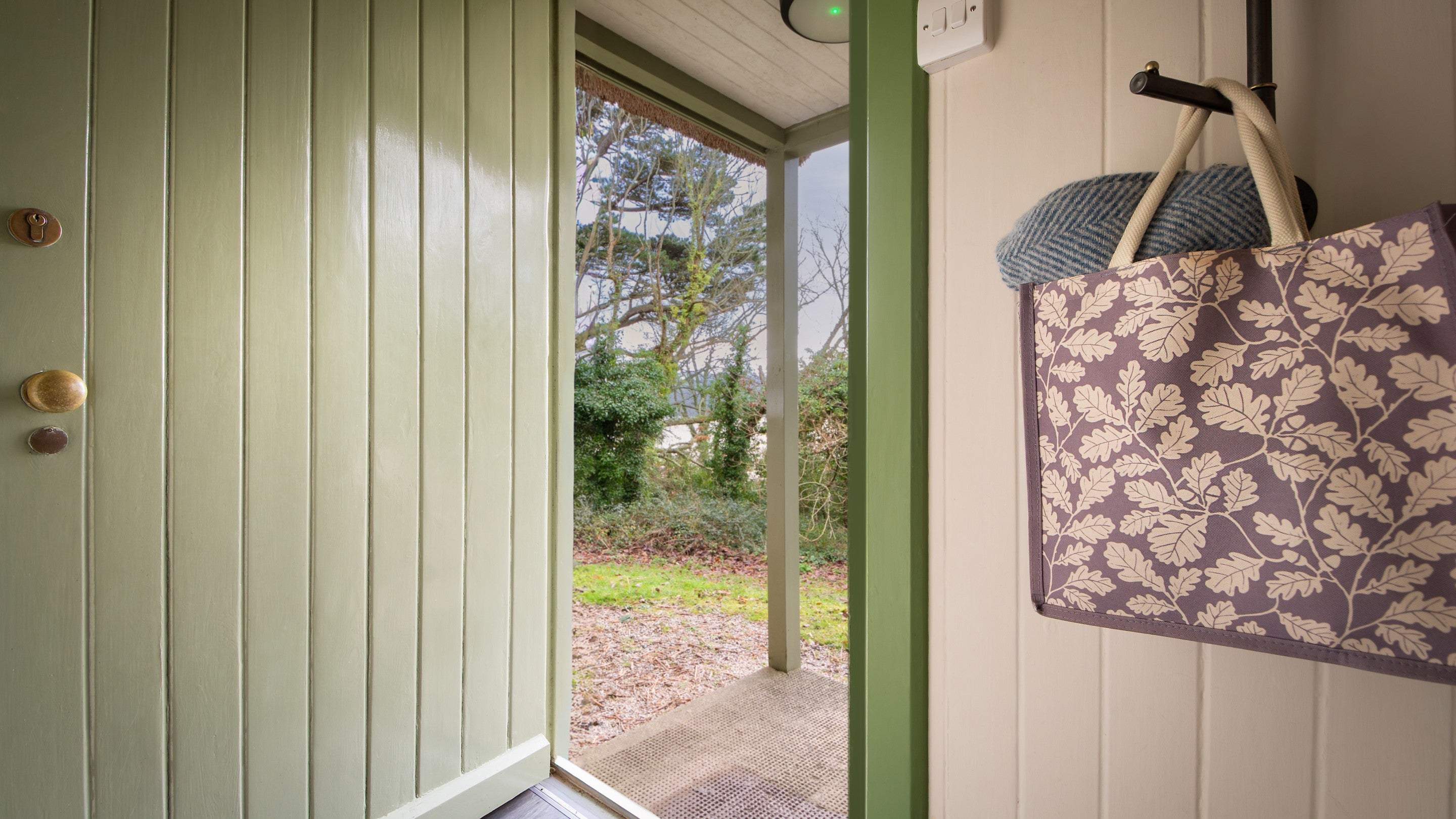 The entrance to Durgan Wood Cottage with a small covered porch, Cornwall