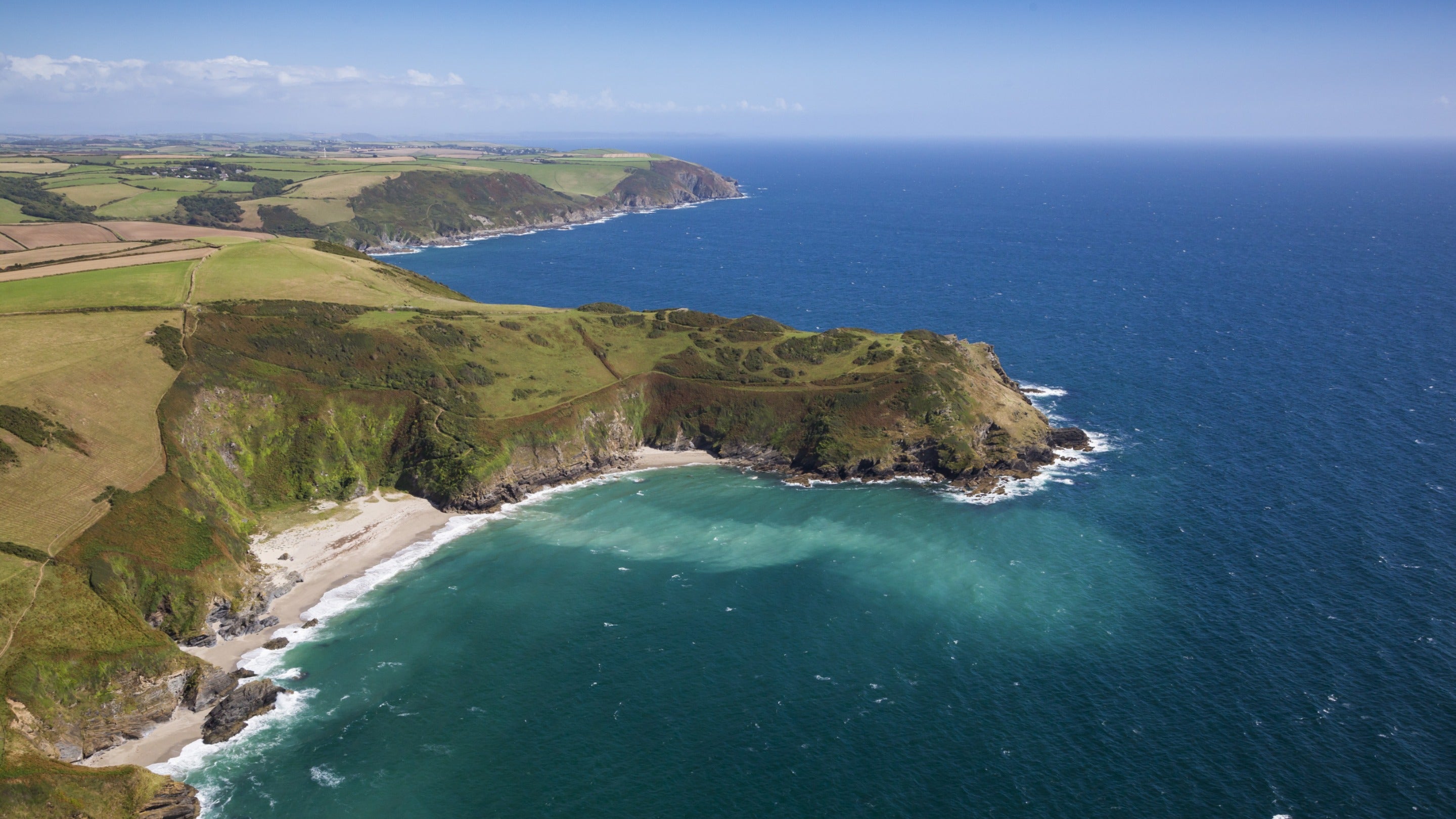 An aerial photo of Lantic Bay's beaches, near Fortescue, Cornwall