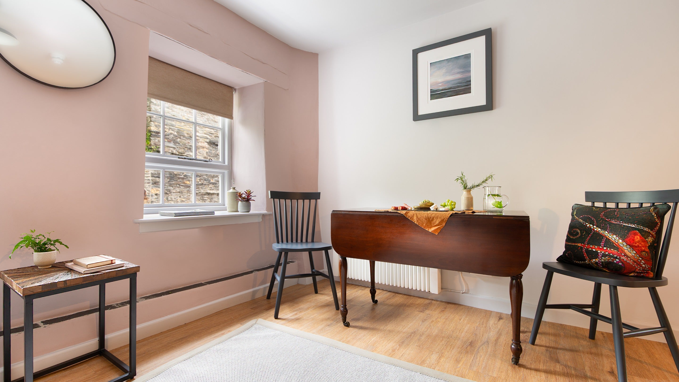 The foldable dining table with two chairs in the open-plan room at The Gaffer, Cornwall