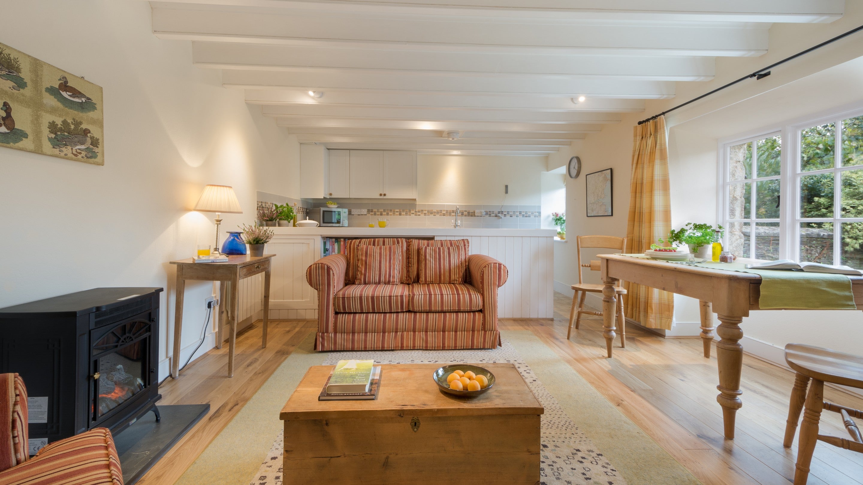 The open-plan kitchen, dining and sitting room at Glebe Cottage, Cornwall