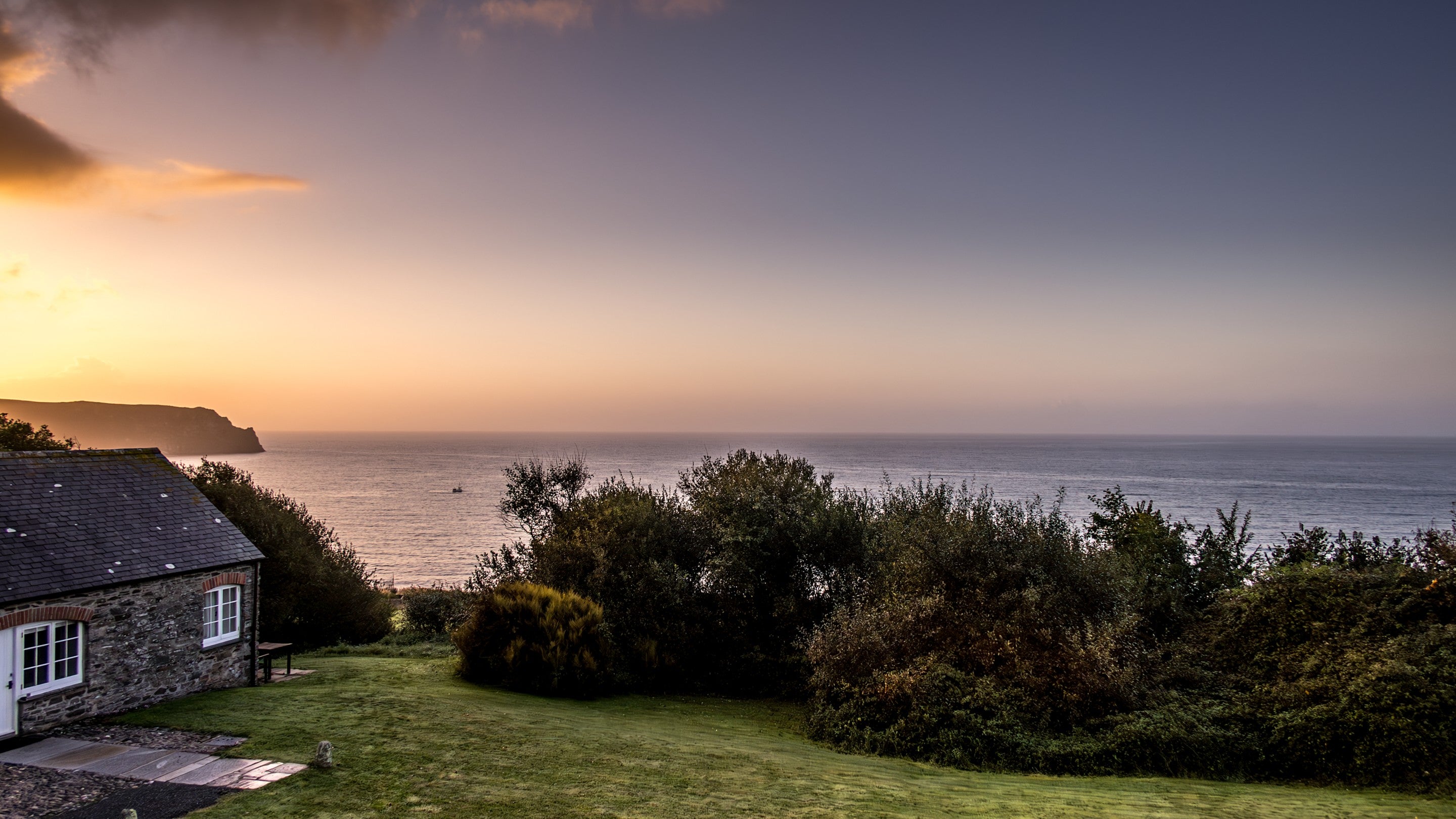 The sea view at the Gwendra cottages at sunrise, with Gwendra Dairy Cottage in the foreground, Cornwall