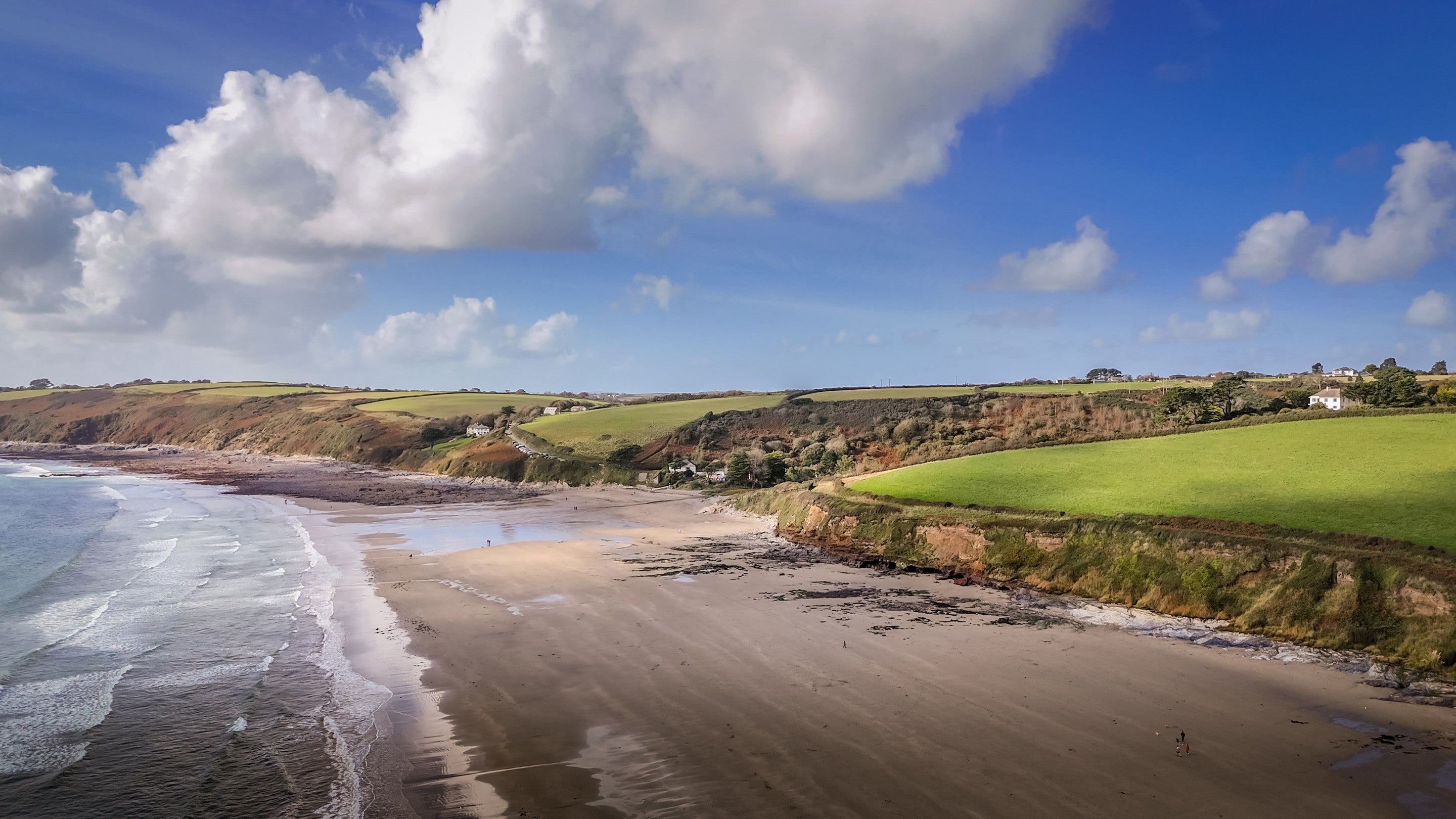 An aerial view of Pendower, a sand beach that is a short walk from the Gwendra cottages, Cornwall