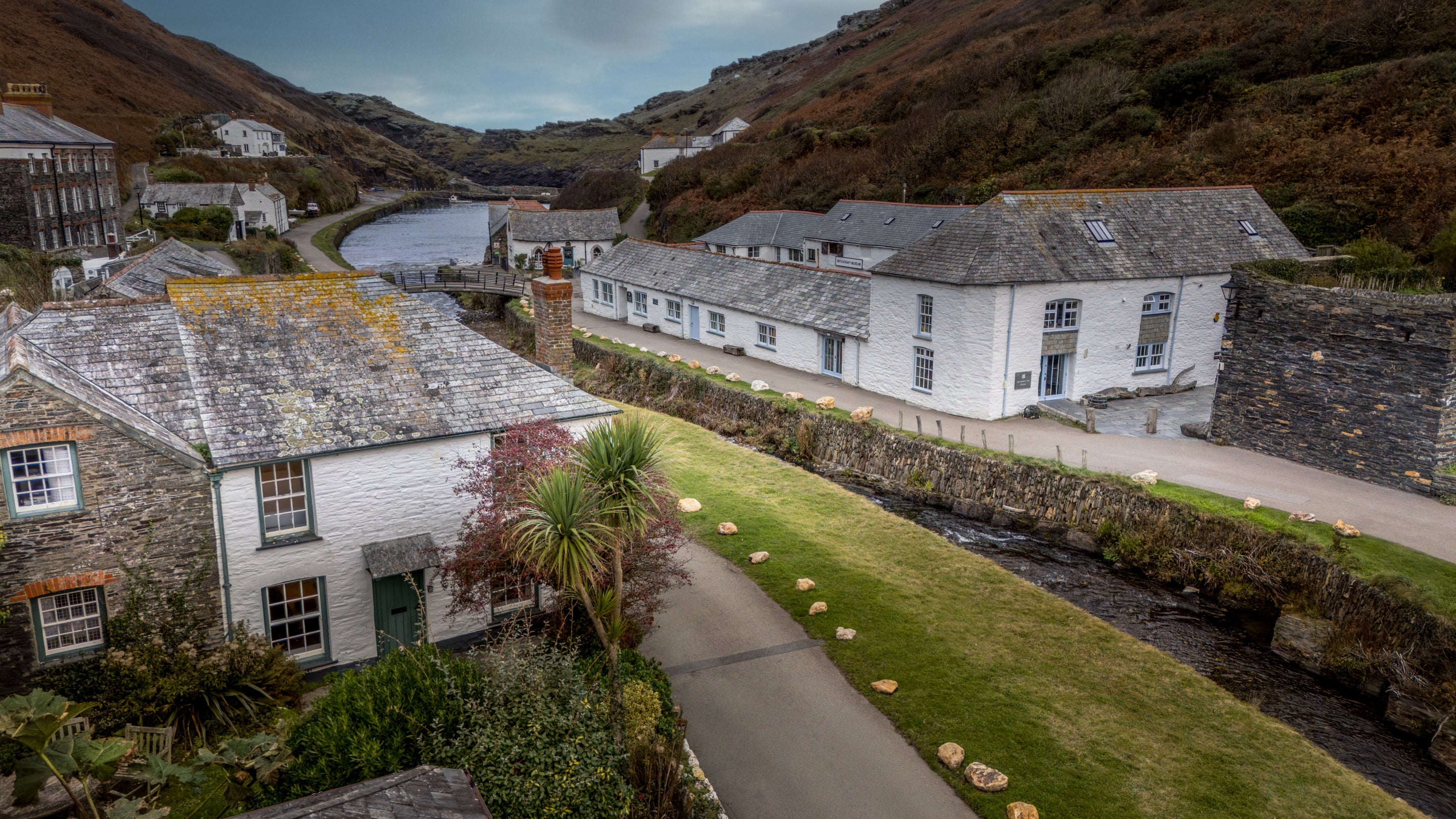 An aerial view of Harbour View (on the left) and Boscastle village, with the River Valency passing next to the cottage, Cornwall