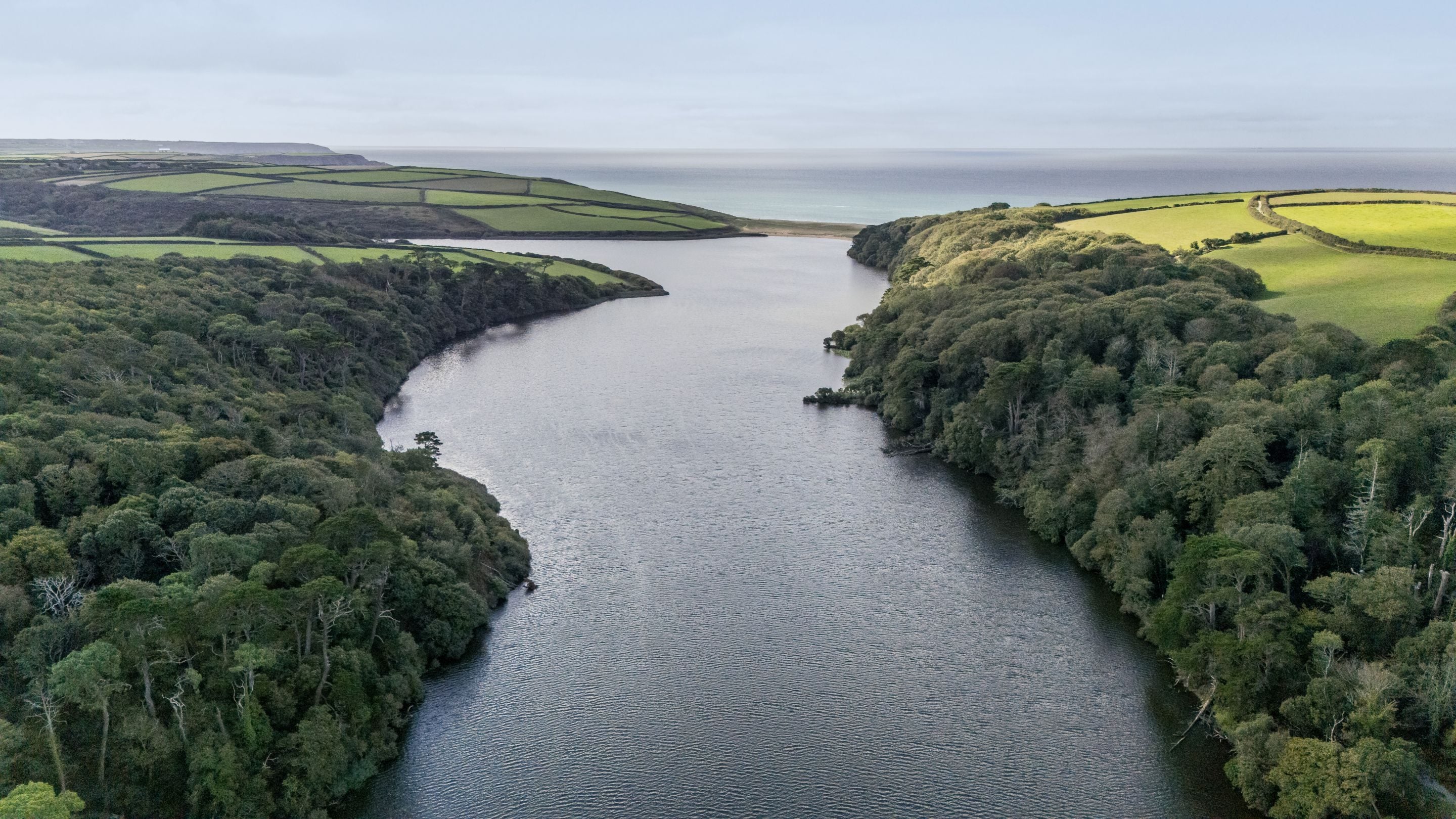 An aerial view across Loe Pool and the surrounding area looking out to sea, Cornwall