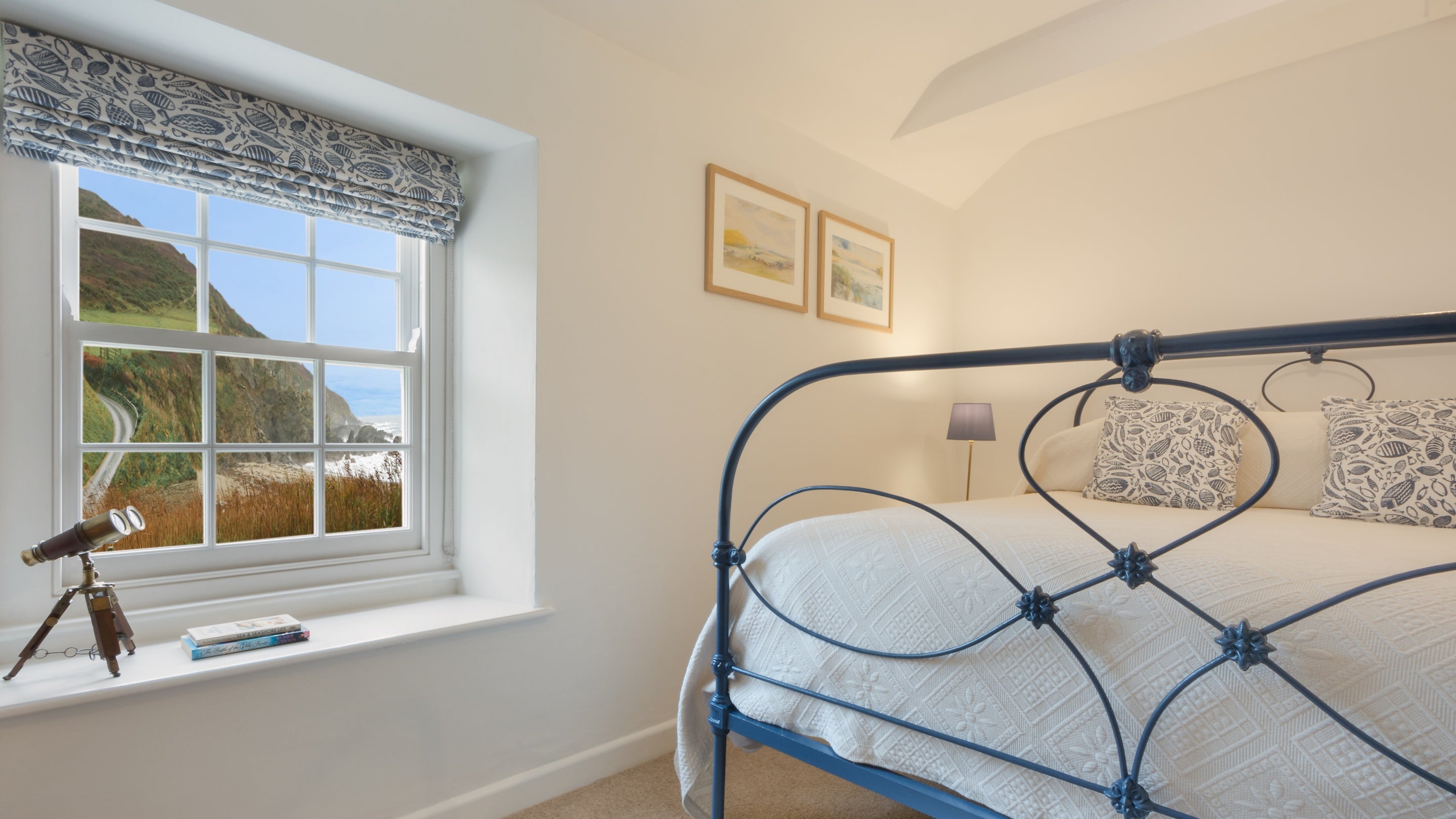 The double bedroom has views over the beach at Hemmick Cottage, Cornwall