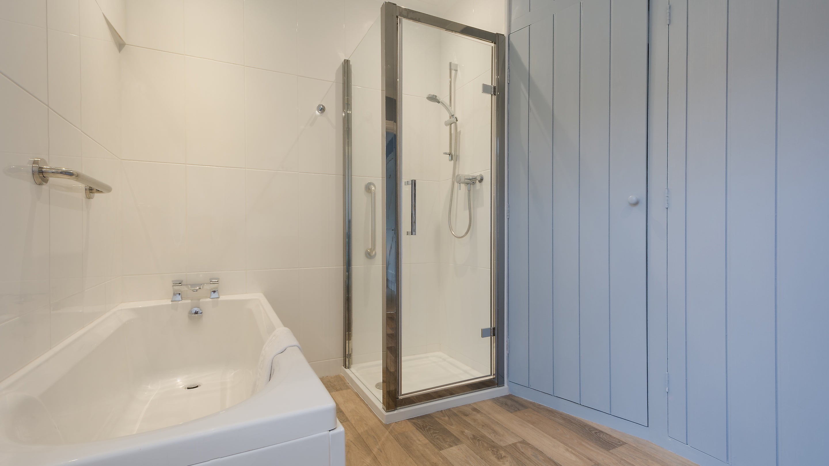 The bathroom with bath and freestanding shower at The Lieutenant's Quarter, Cornwall