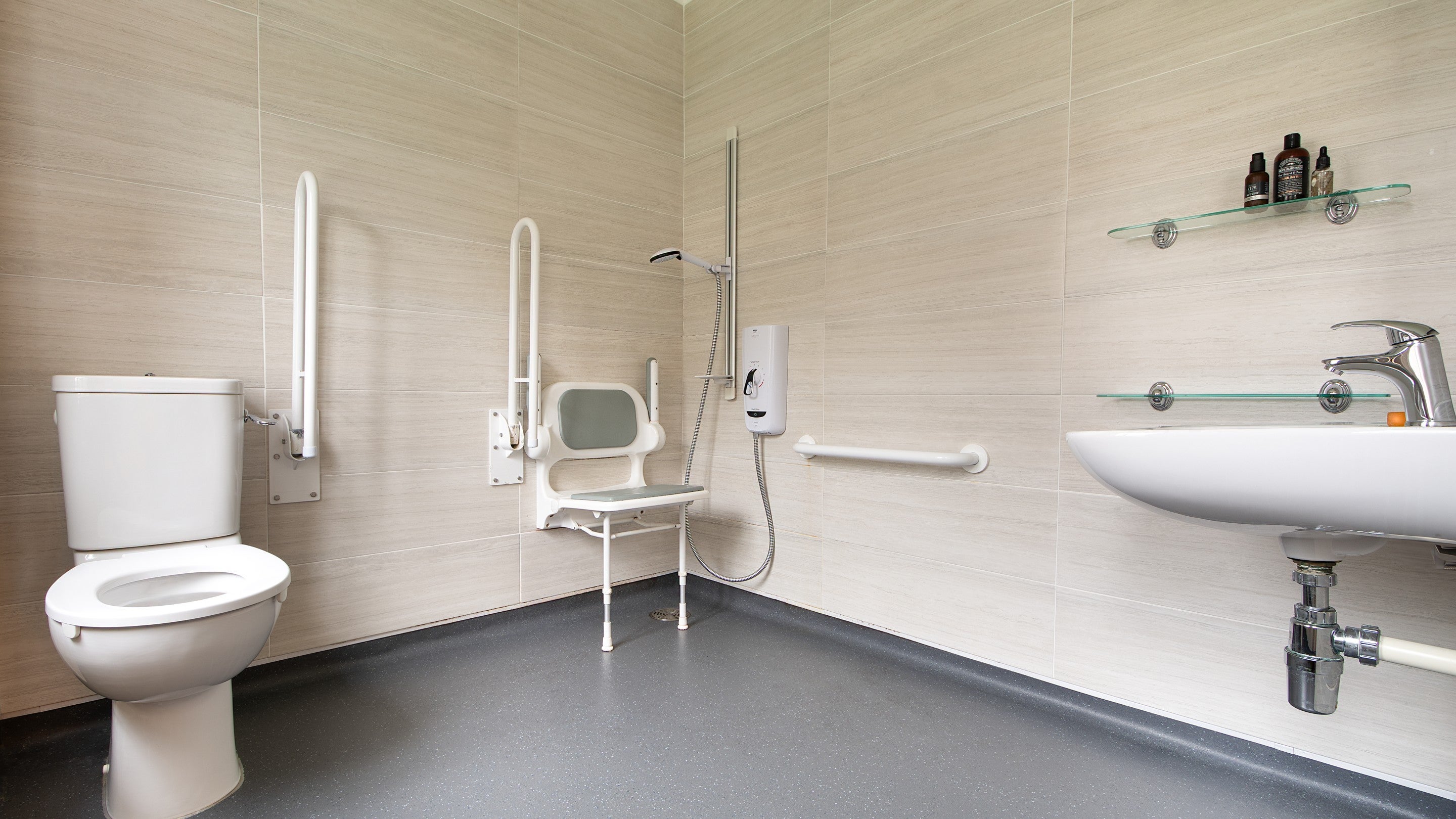 The wet room, with grab rails and hinged shower seat, at The Major's Quarter, Cornwall