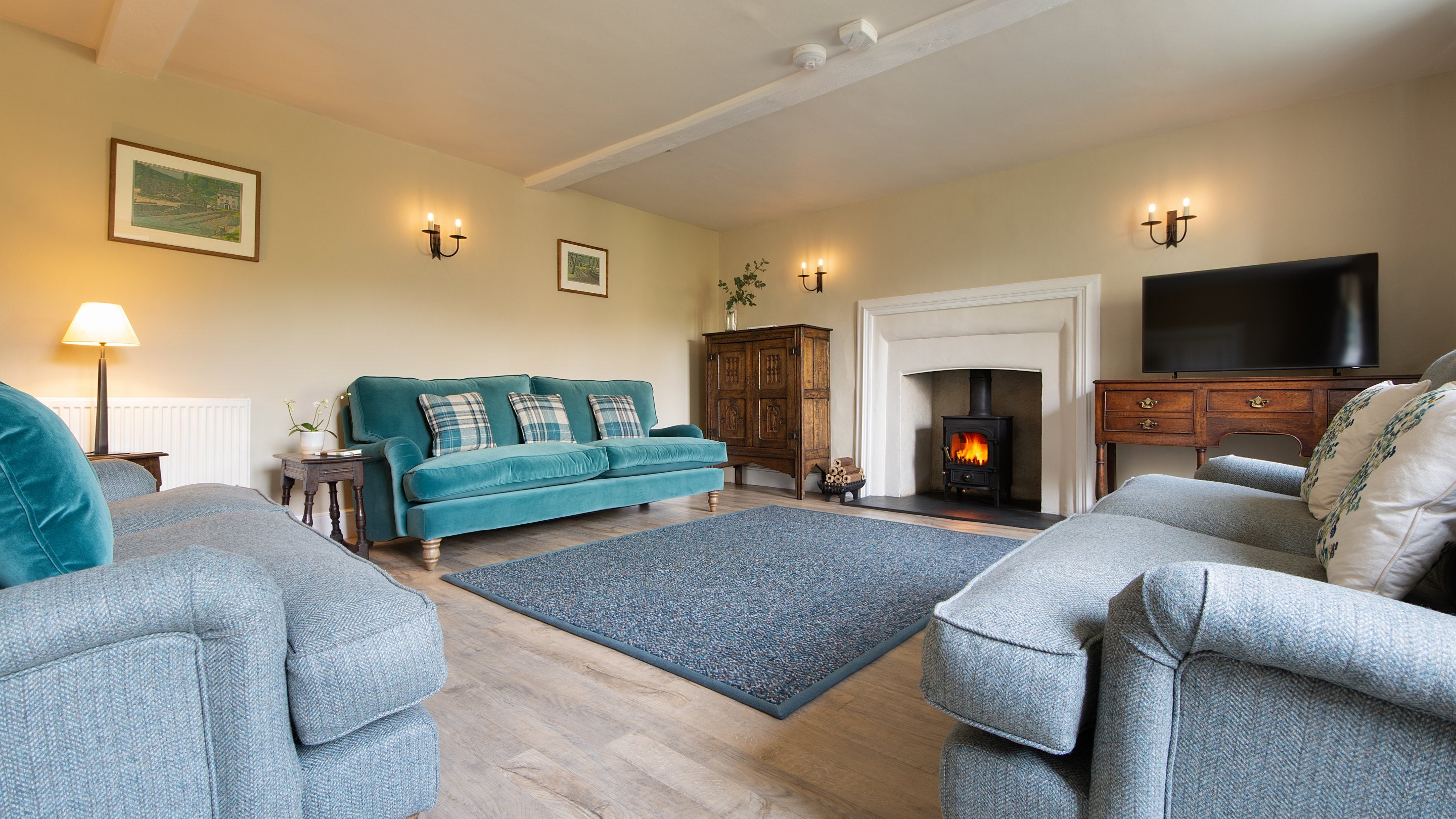 The sitting room with woodburner, sofas and television at Malt House, Cornwall