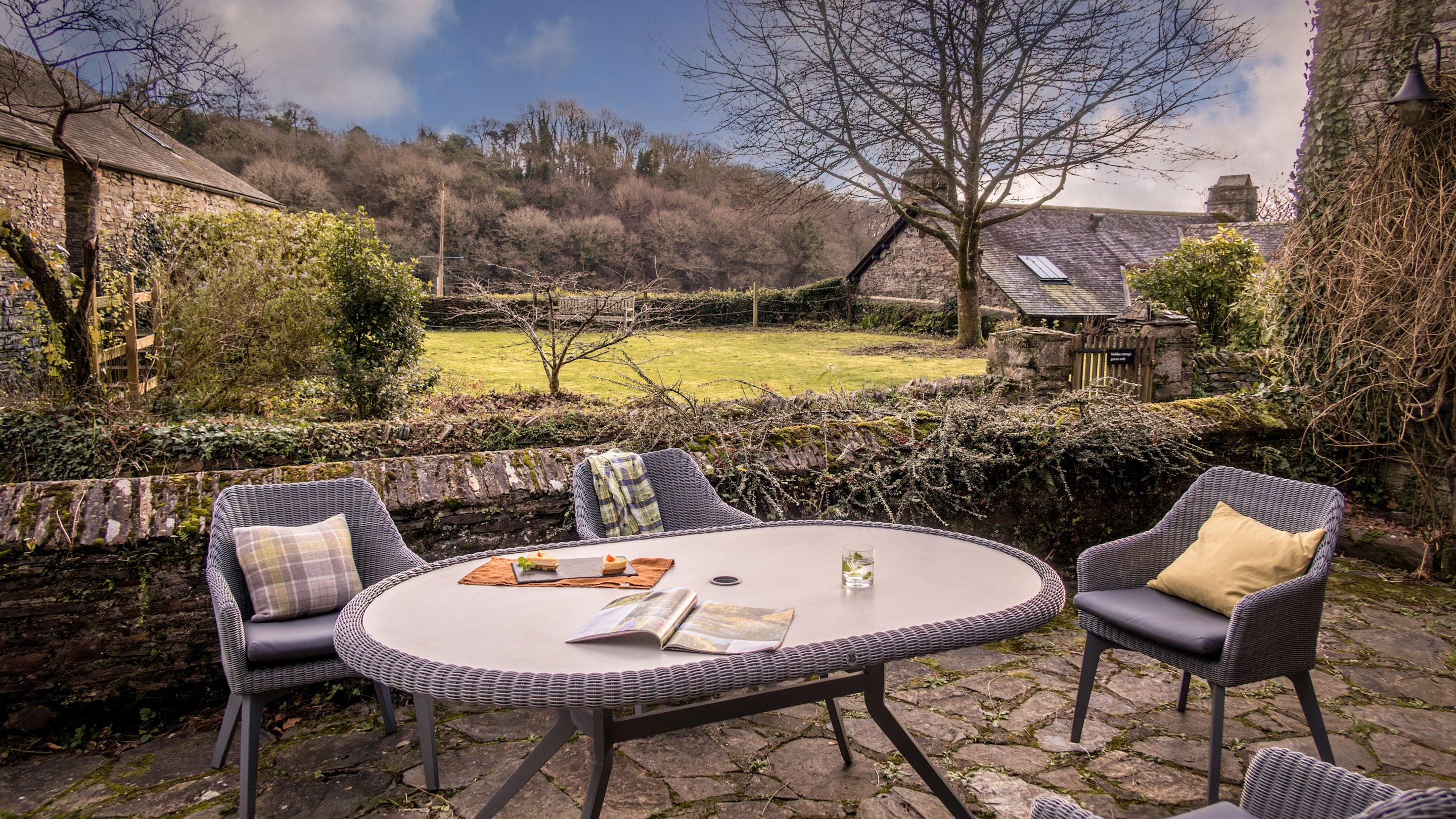 The patio with table and chairs at Malt House in winter, Cornwall