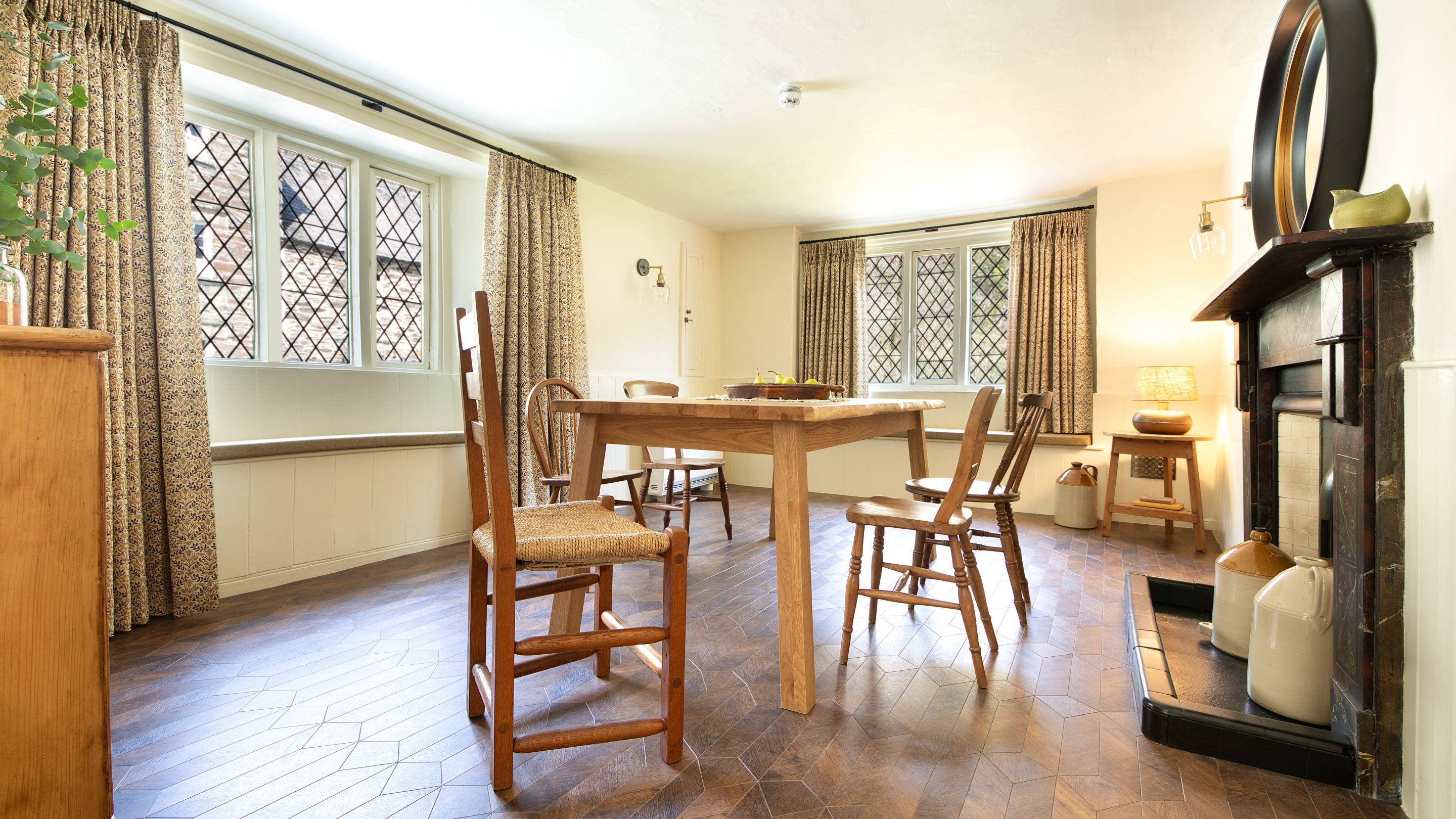 The dining room at Miller's House, with window seats at the two latticed windows, Cornwall