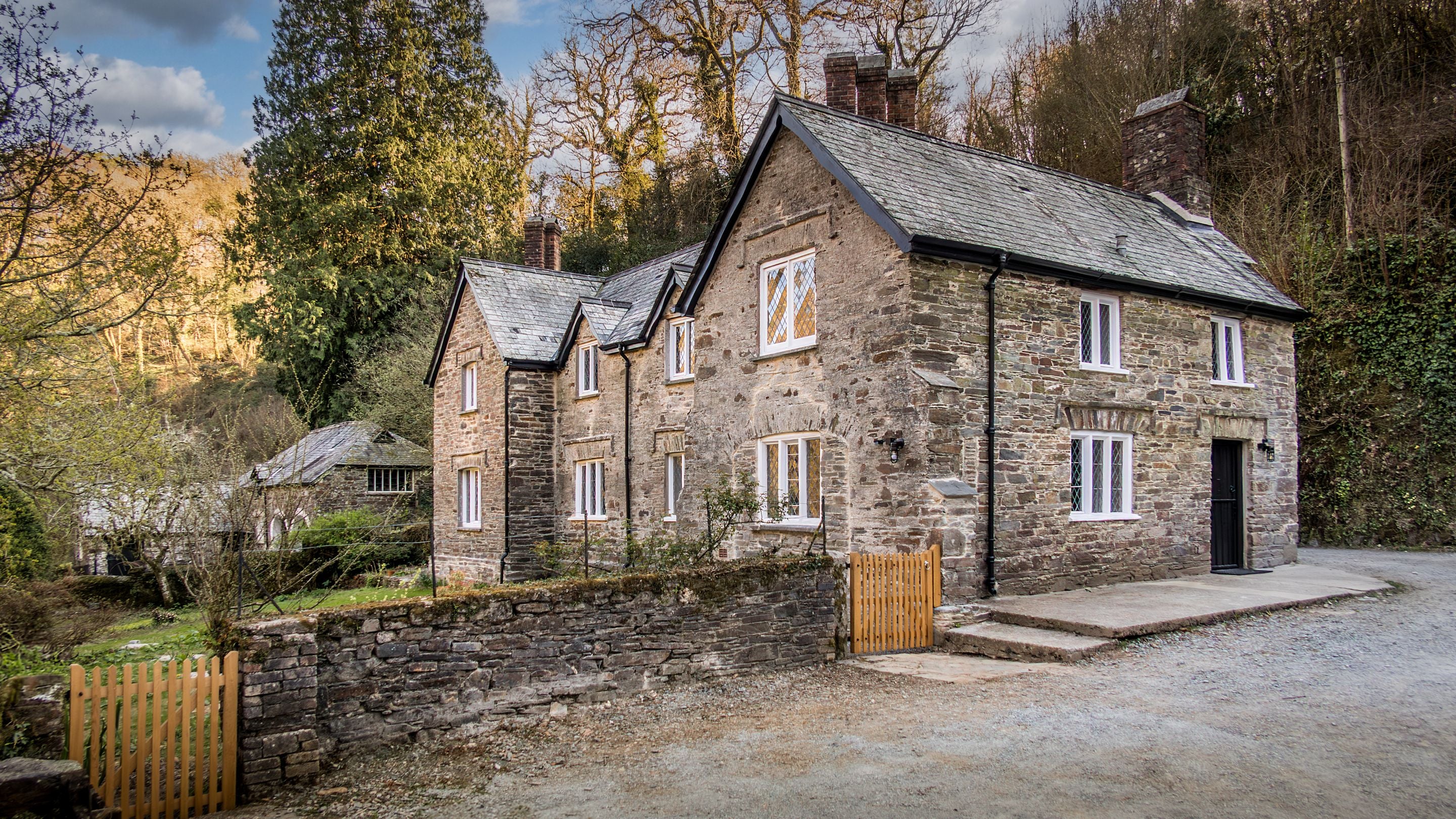 The side of Miller's House and its enclosed garden with lawn, Cornwall