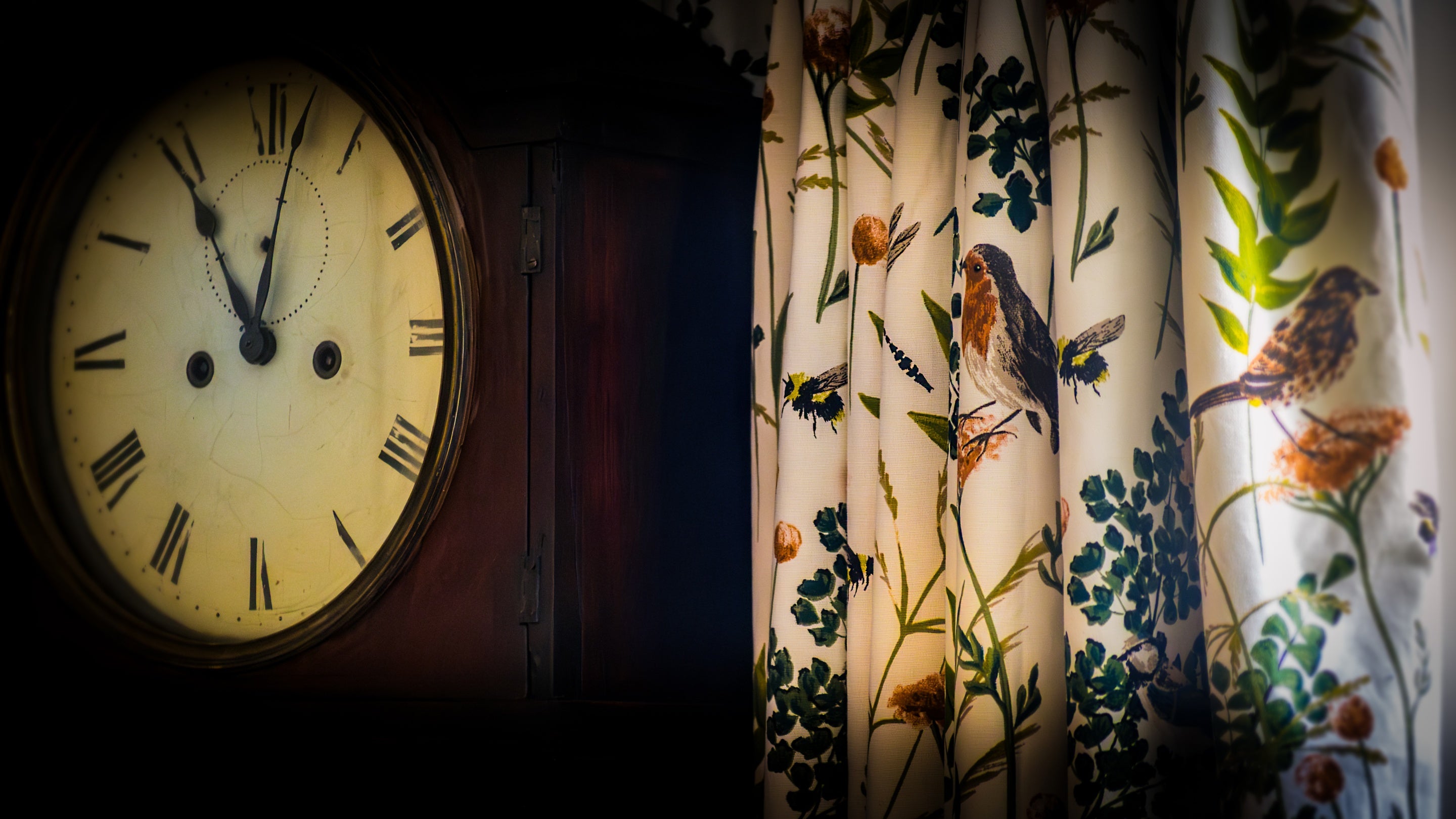 The clock and curtains in the dining room at Nanceglos House, Cornwall
