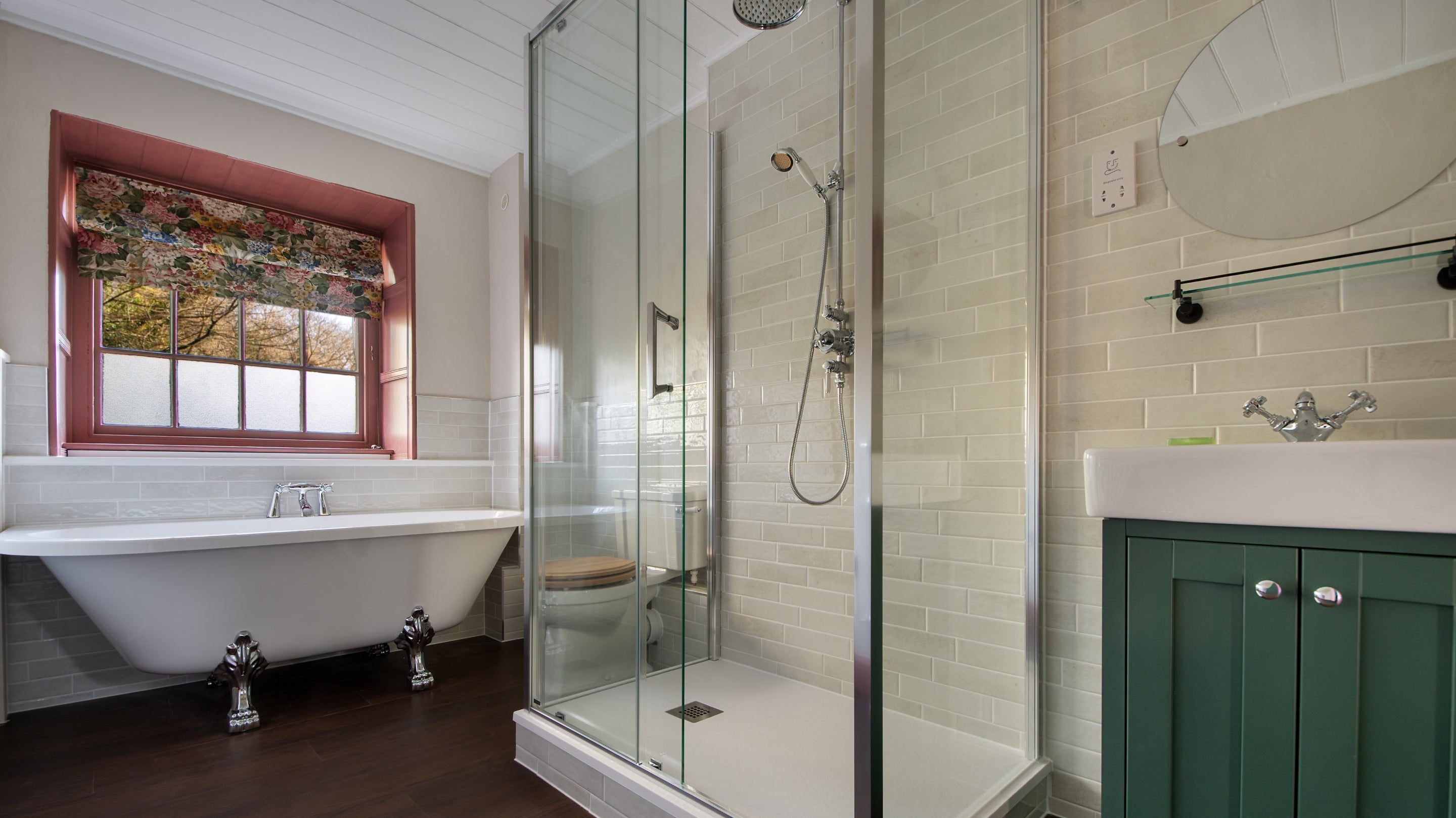 The ground-floor bathroom at Nanceglos House, with a roll-top bath and separate shower, Cornwall