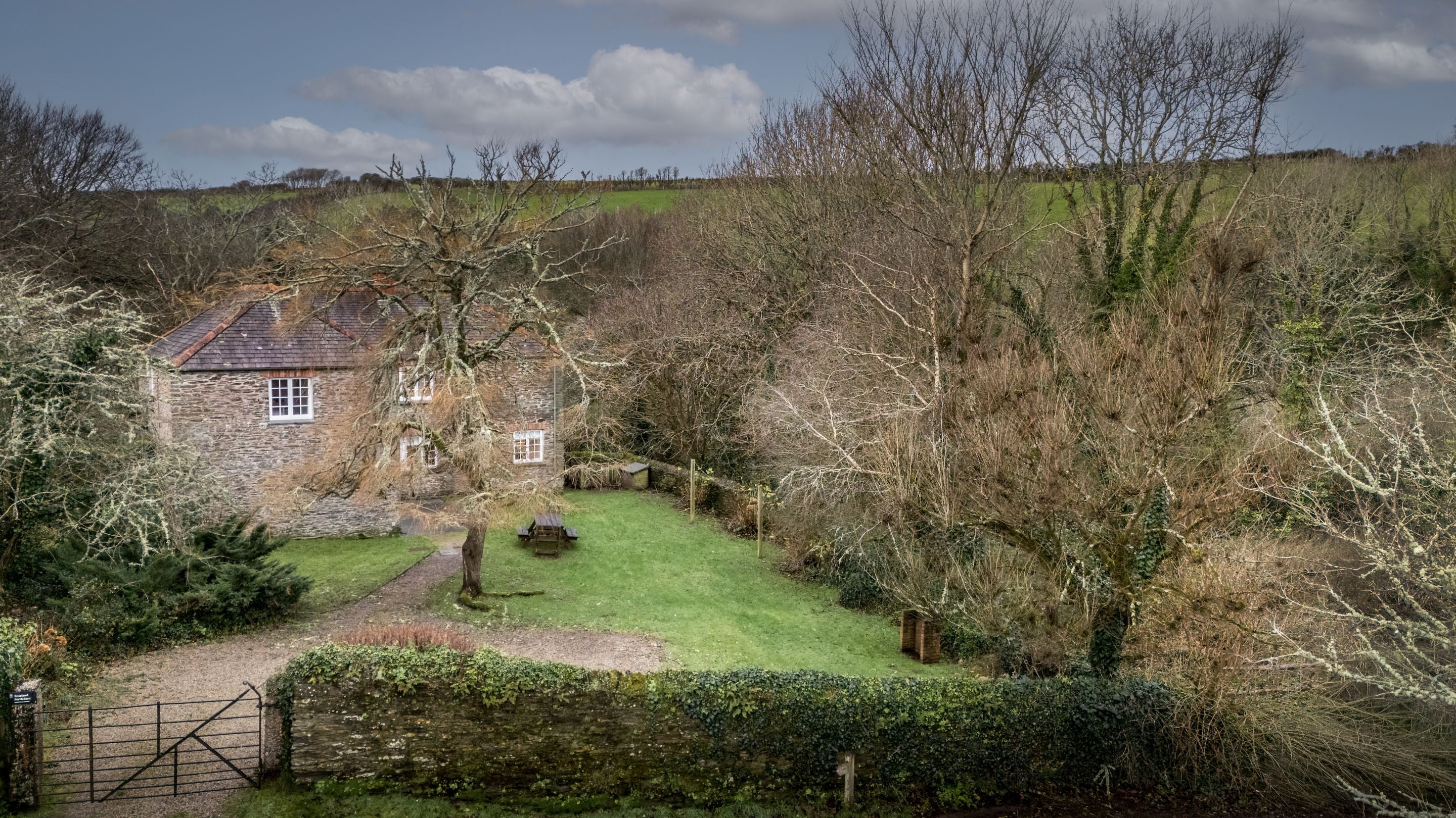 An aerial view of Roseland Porth Barn, its garden and car parking space, Cornwall