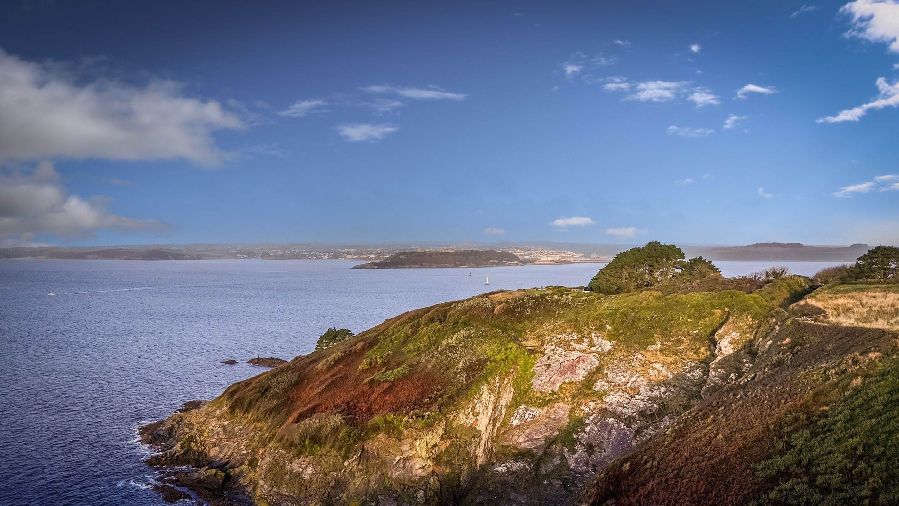 The rocky headland at St Anthony Head, with views of the estuary and Falmouth in the distance, Cornwall