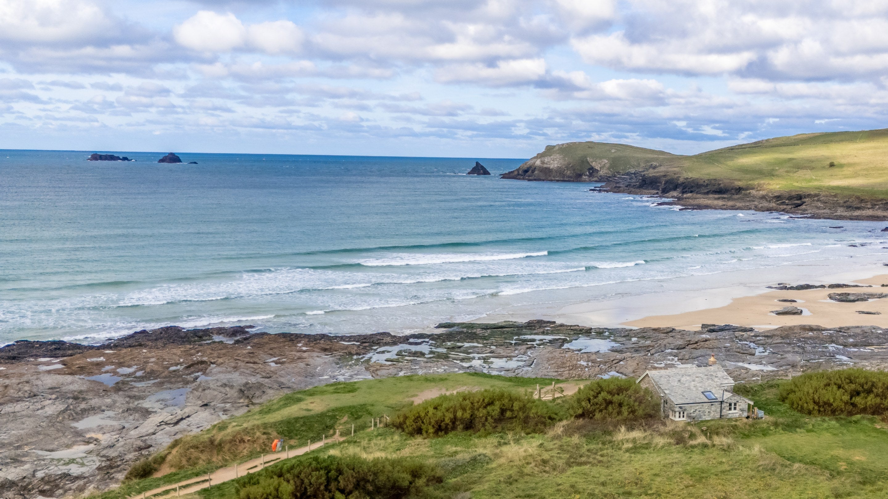 An aerial view of Tom Parsons' Hut, with the beach at Booby's Bay and Trevose Headland in the background, Cornwall