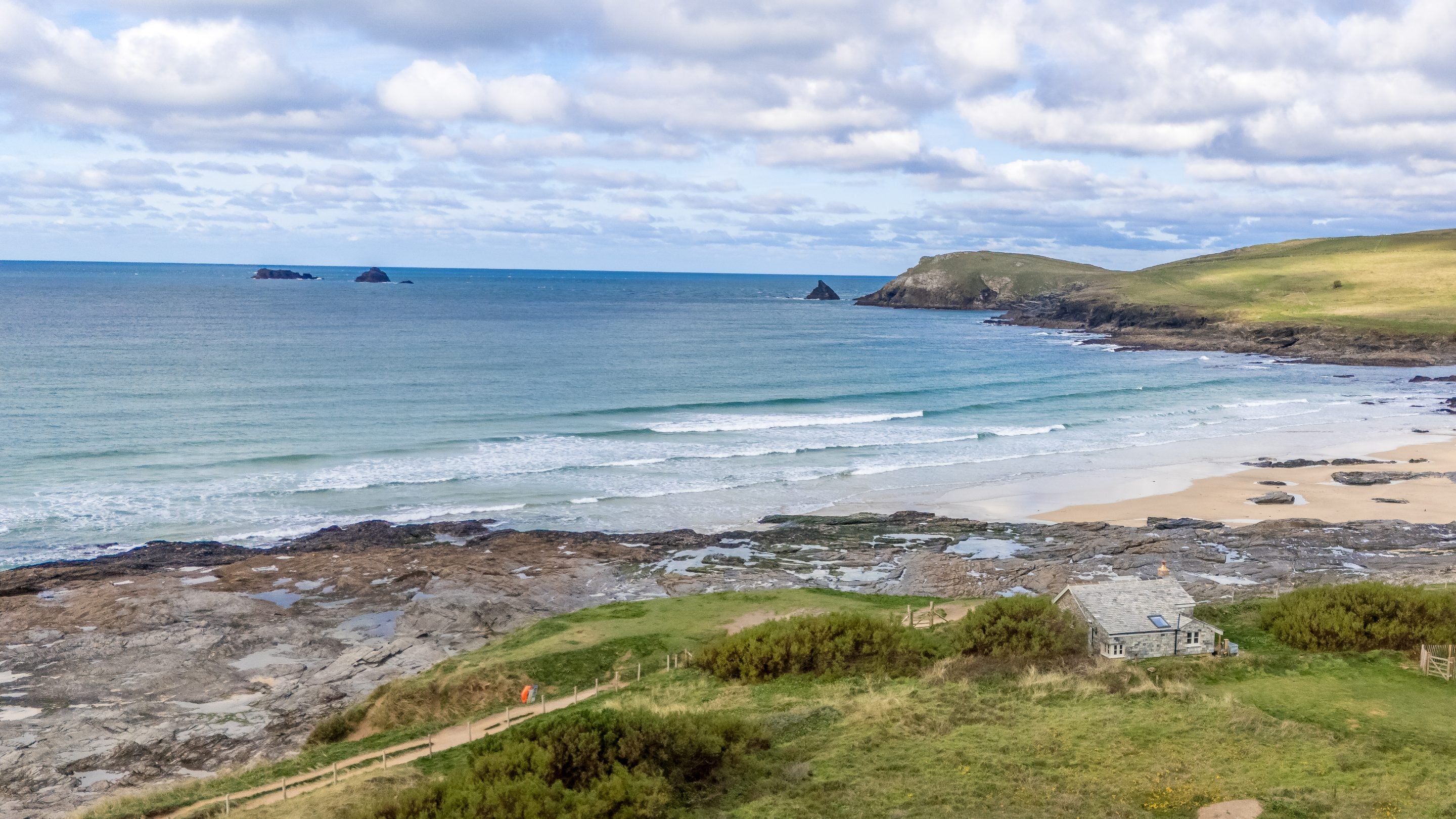 An aerial view of Tom Parsons' Hut, with Booby's Bay and Trevose Head in the background, Cornwall