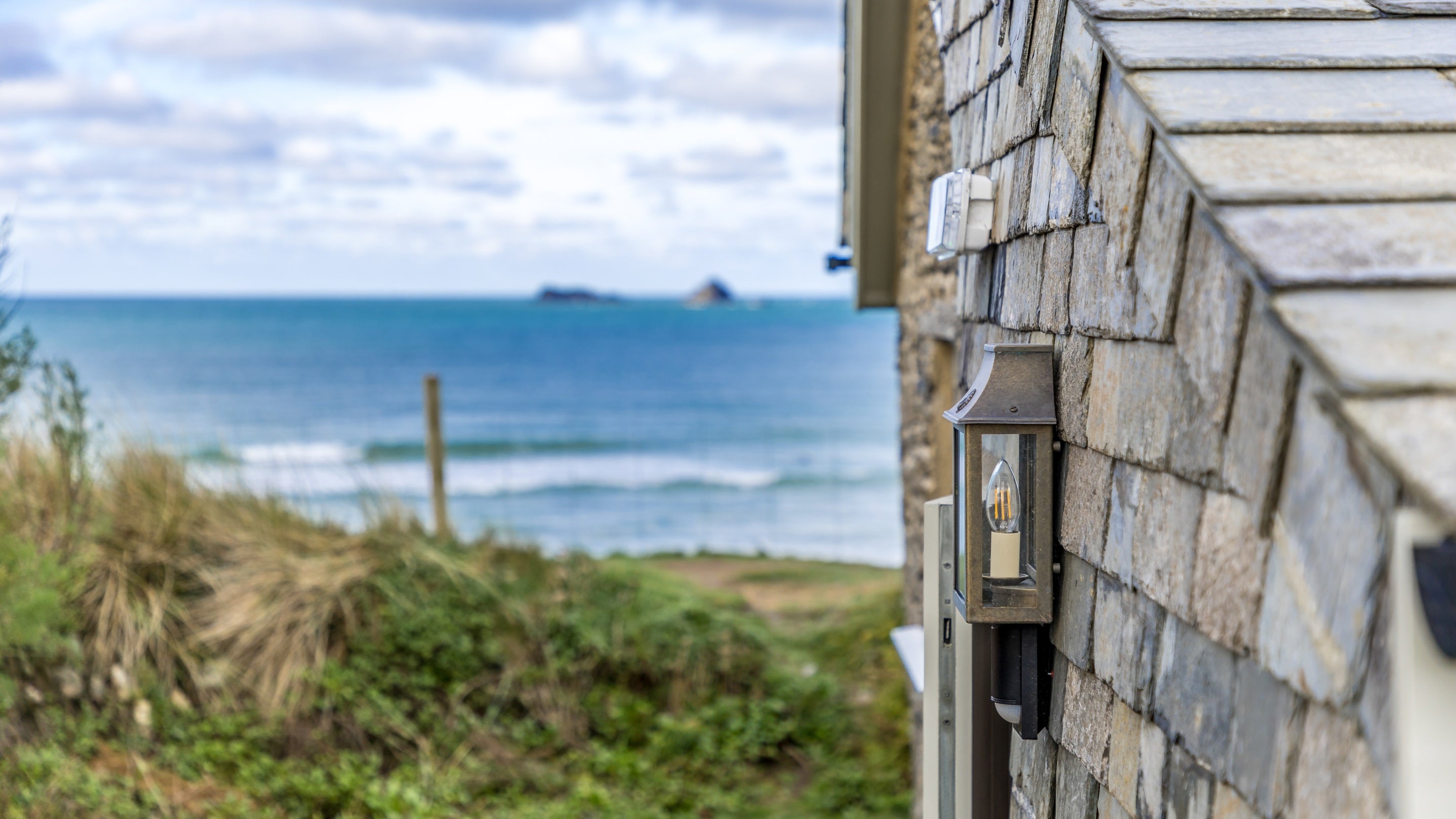 The side of Tom Parsons' Hut with the sea in the distance, Cornwall
