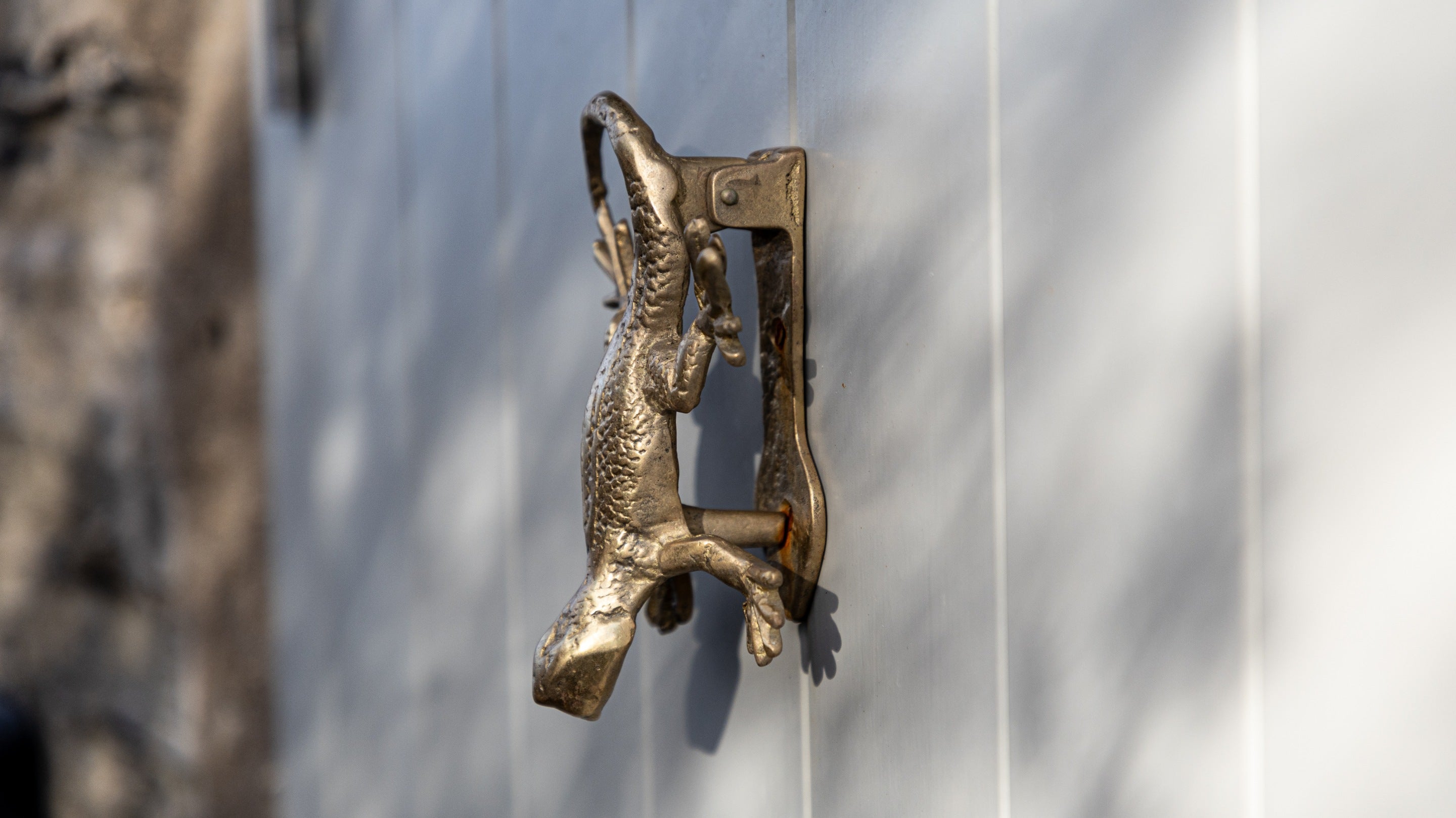 The brass door knocker, in the shape of a lizard, on the entrance door to Tom Parsons' Hut, Cornwall