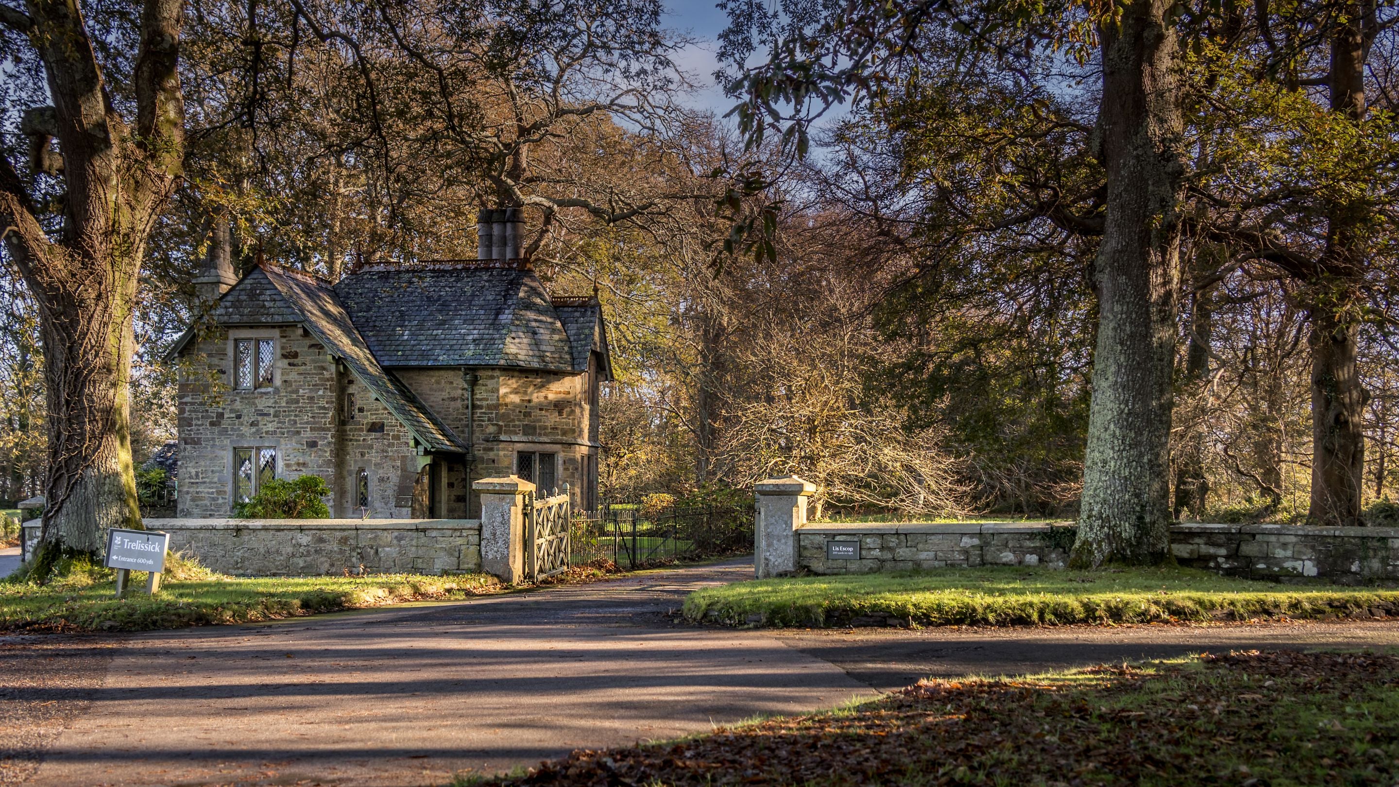 Trelissick New Lodge, surrounded by trees and by the road to the Trelissick estate, Cornwall