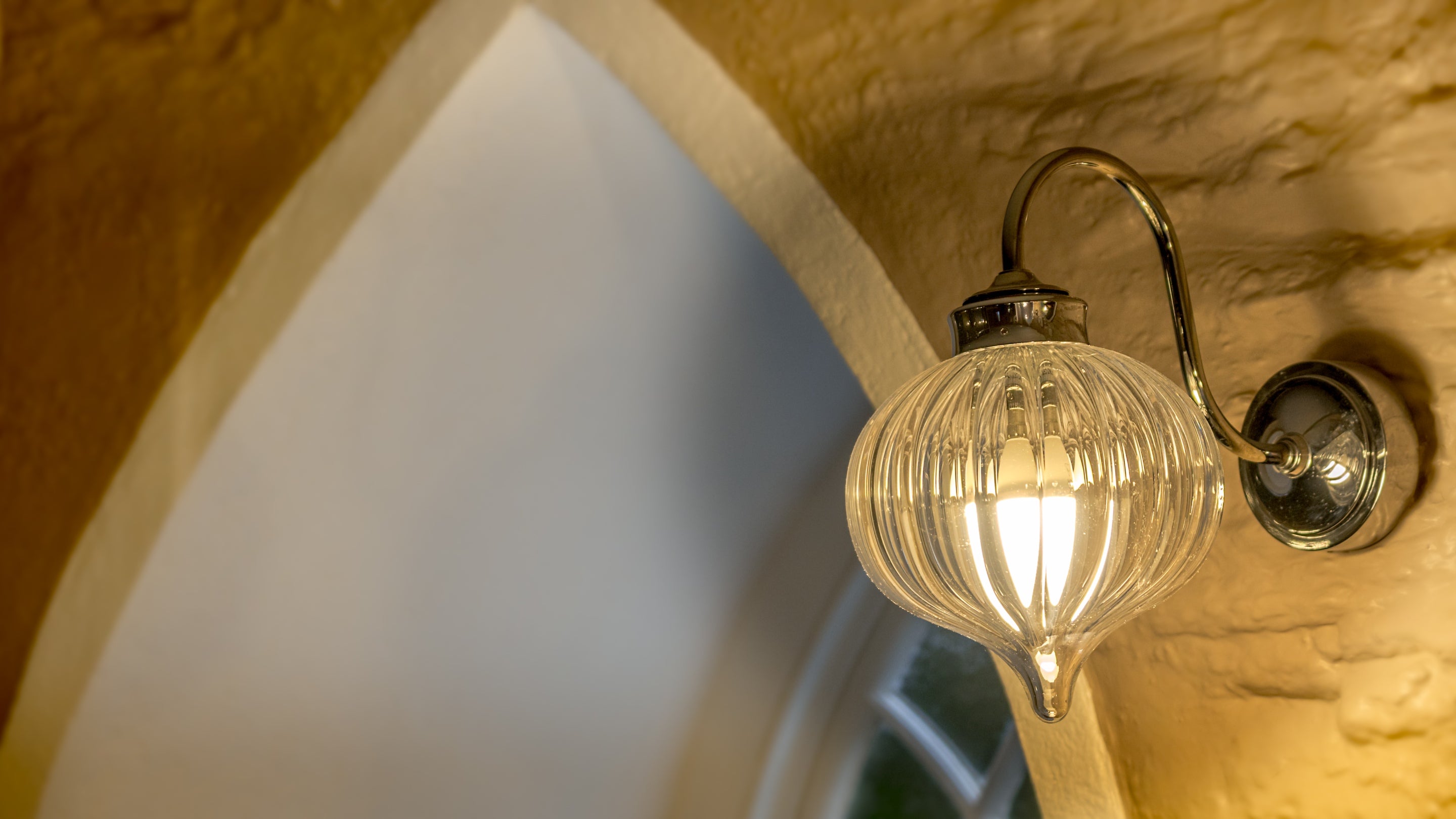 A glass wall light in the shower room at Trelissick Water Tower, Cornwall