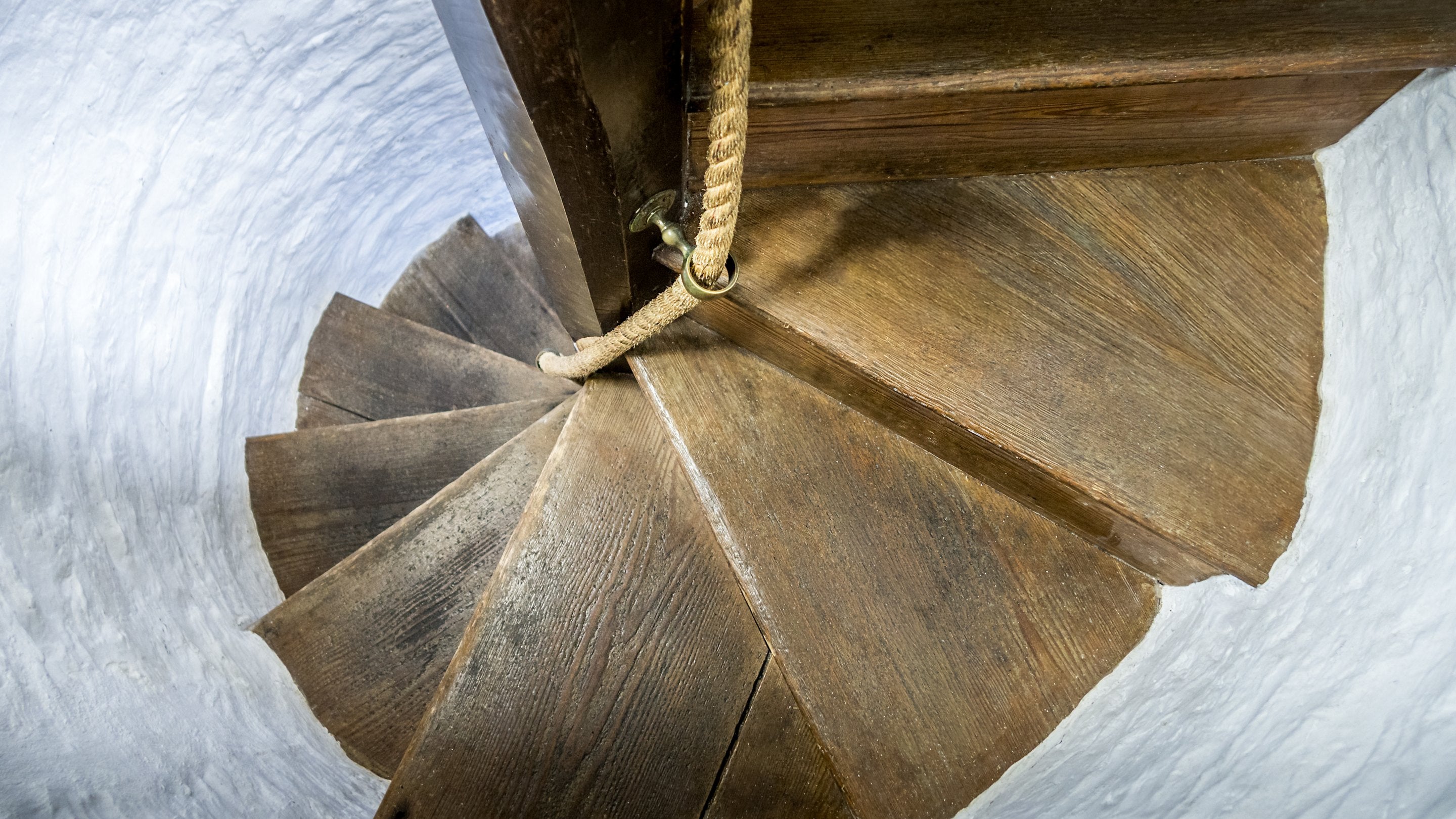 The enclosed spiral staircase, which is steep and narrow, with rope handrail at Trelissick Water Tower, Cornwall
