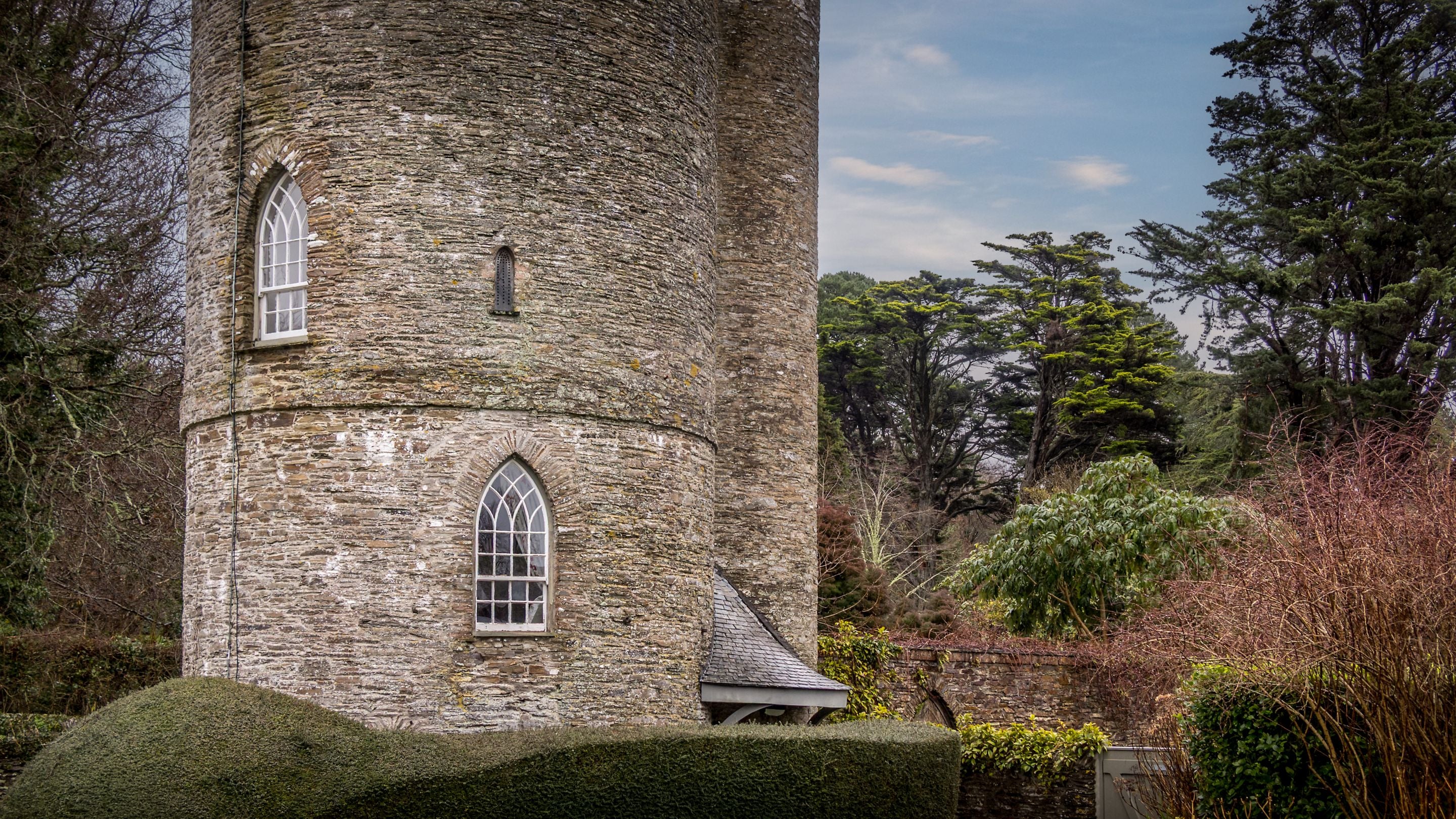The exterior, curved stone walls of Trelissick Water Tower, Cornwall